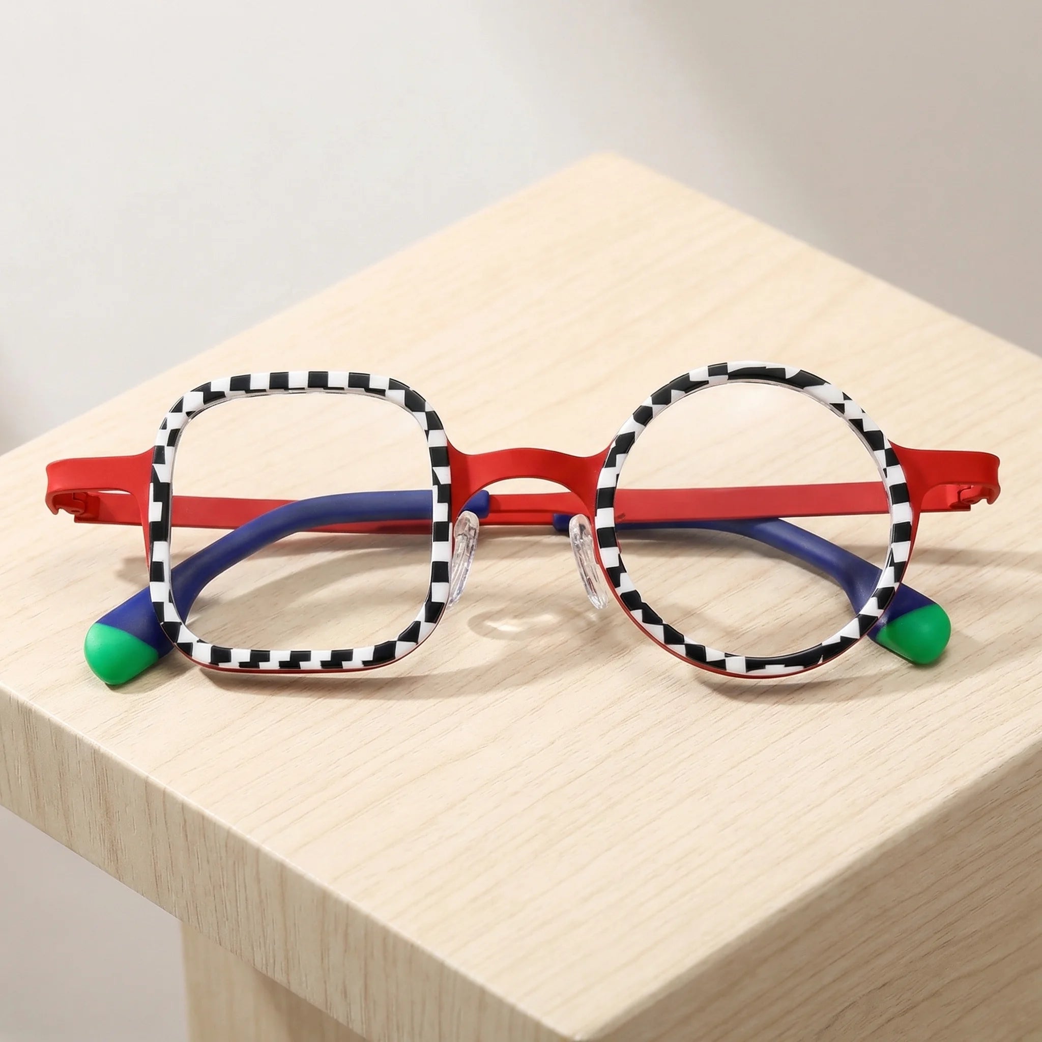 Folded view of VoyueLens Checker Clash Red eyeglasses showing compact structure and flexible temples, a distinctive BARLEDEAR design.