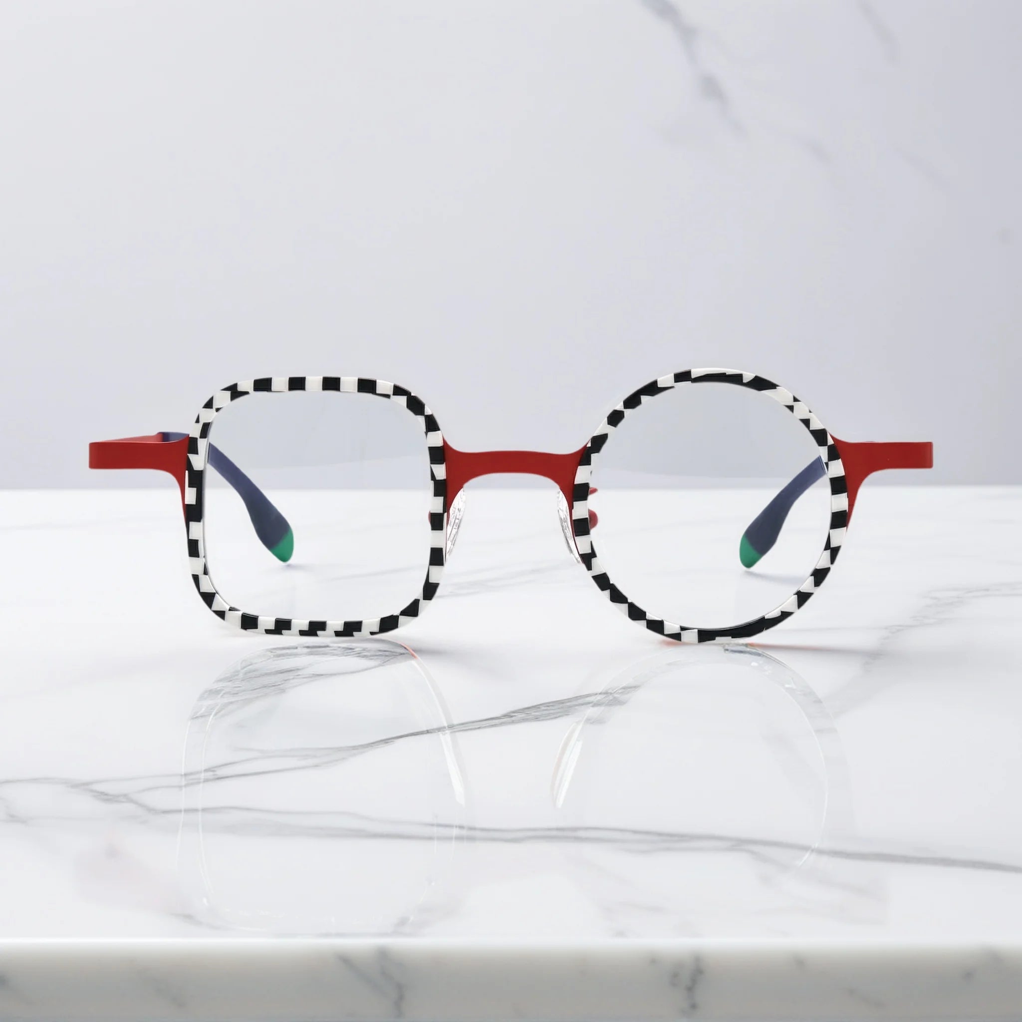 Front view of VoyueLens Checker Clash Red eyeglasses with high-contrast checker rims and asymmetrical dual-shape frame, part of the BARLEDEAR collection.