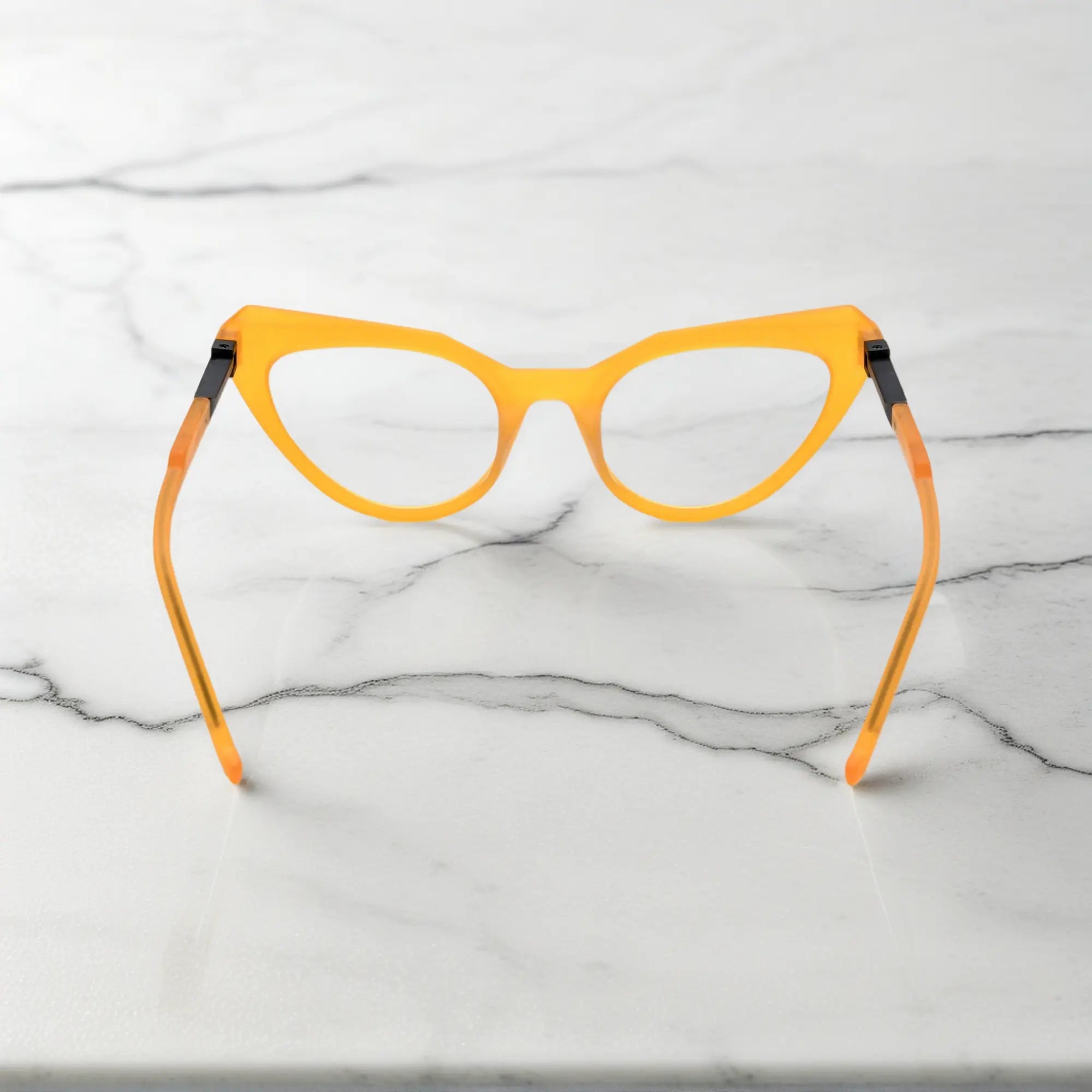 Rear view highlighting the fiery amber coloration of the butterfly-shaped acetate frame.