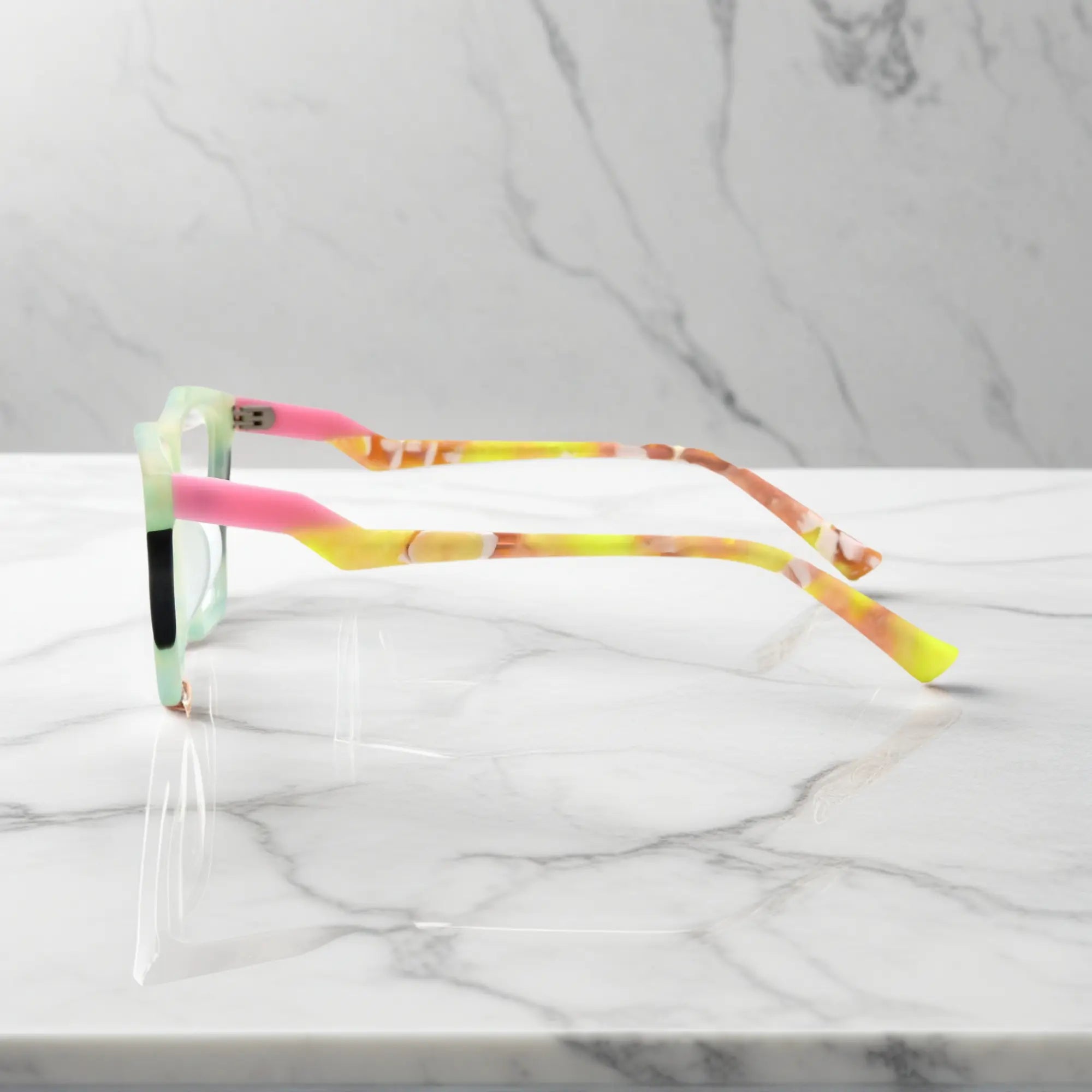 Side profile of VoyueLens™ Citrus Fade glasses, highlighting lime green front with pink-accented temples and ergonomic acetate arms.