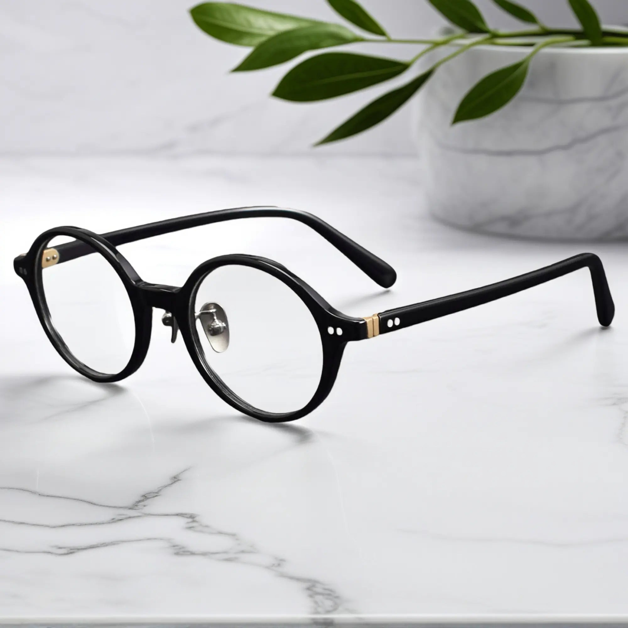 Black round eyeglasses showing titanium nose pads and metal-insert hinges