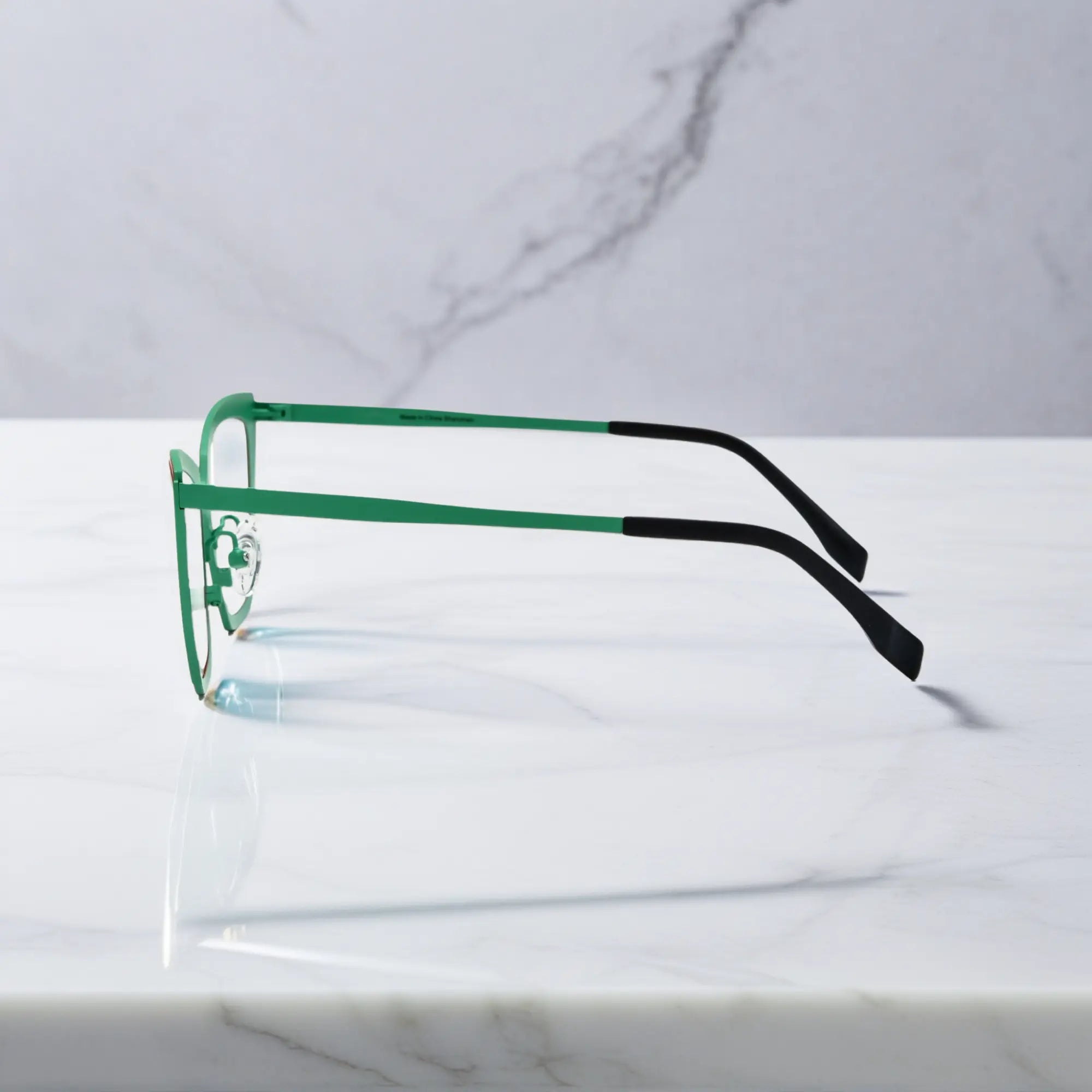 Side profile of red-green VoyueLens™ VL185809 cat-eye titanium glasses