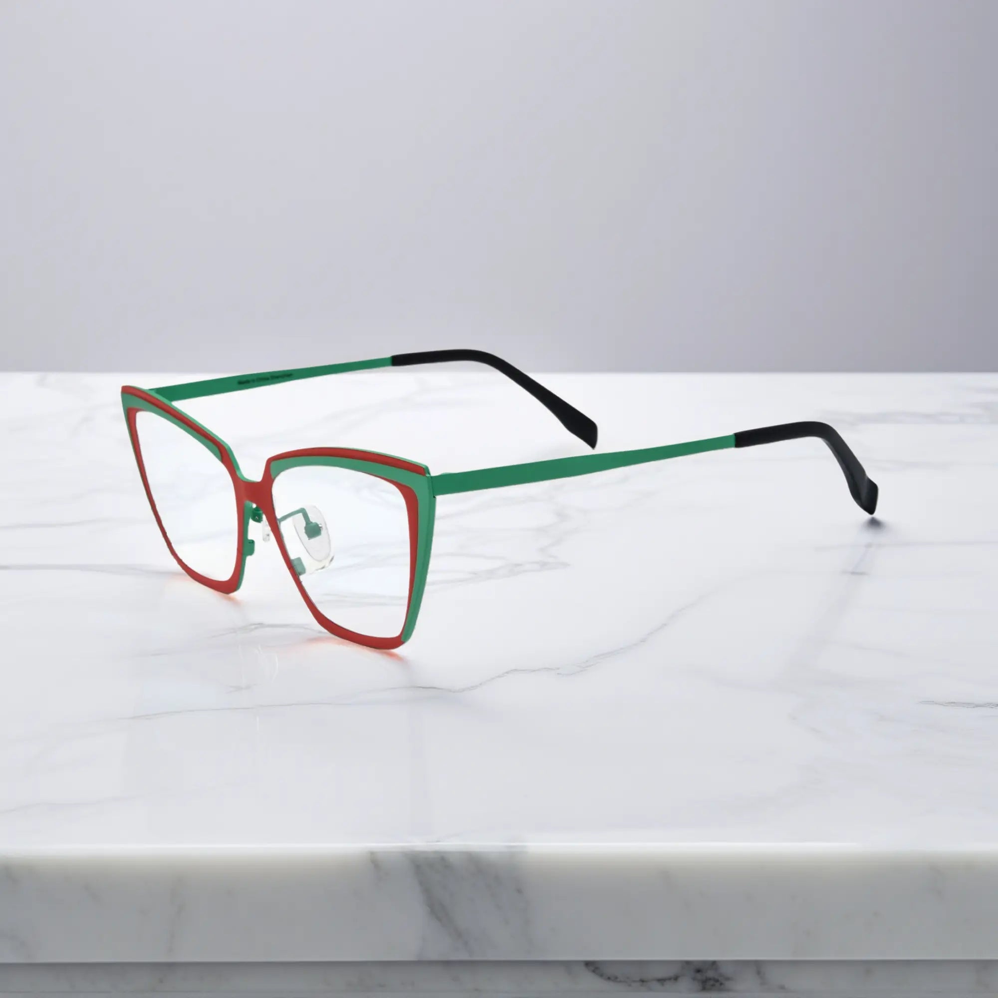 Side view of red-green VoyueLens™ VL185809 cat-eye titanium glasses
