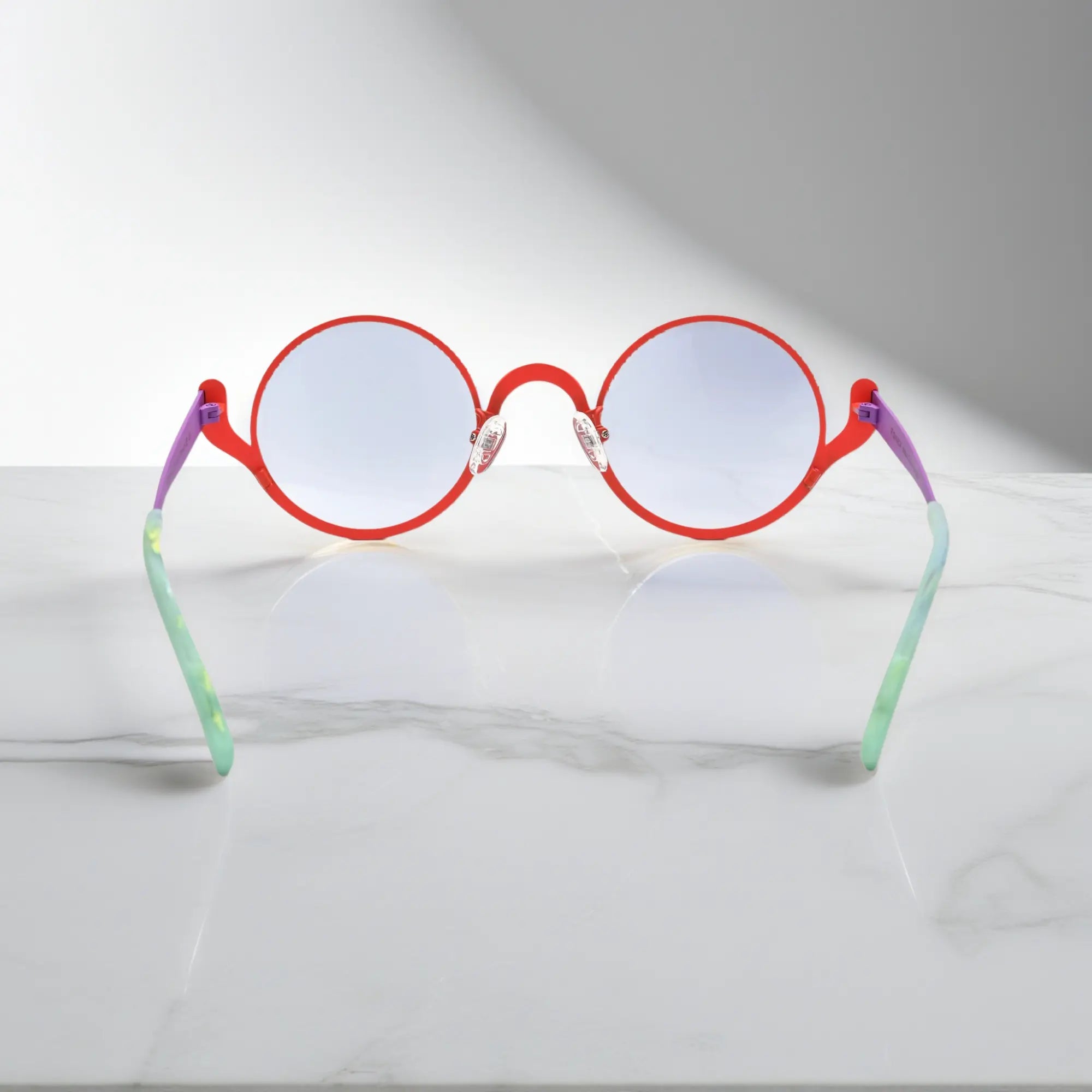 Back view of Crimson Ice VoyueLens™ titanium round eyeglasses – full-rim detail shown