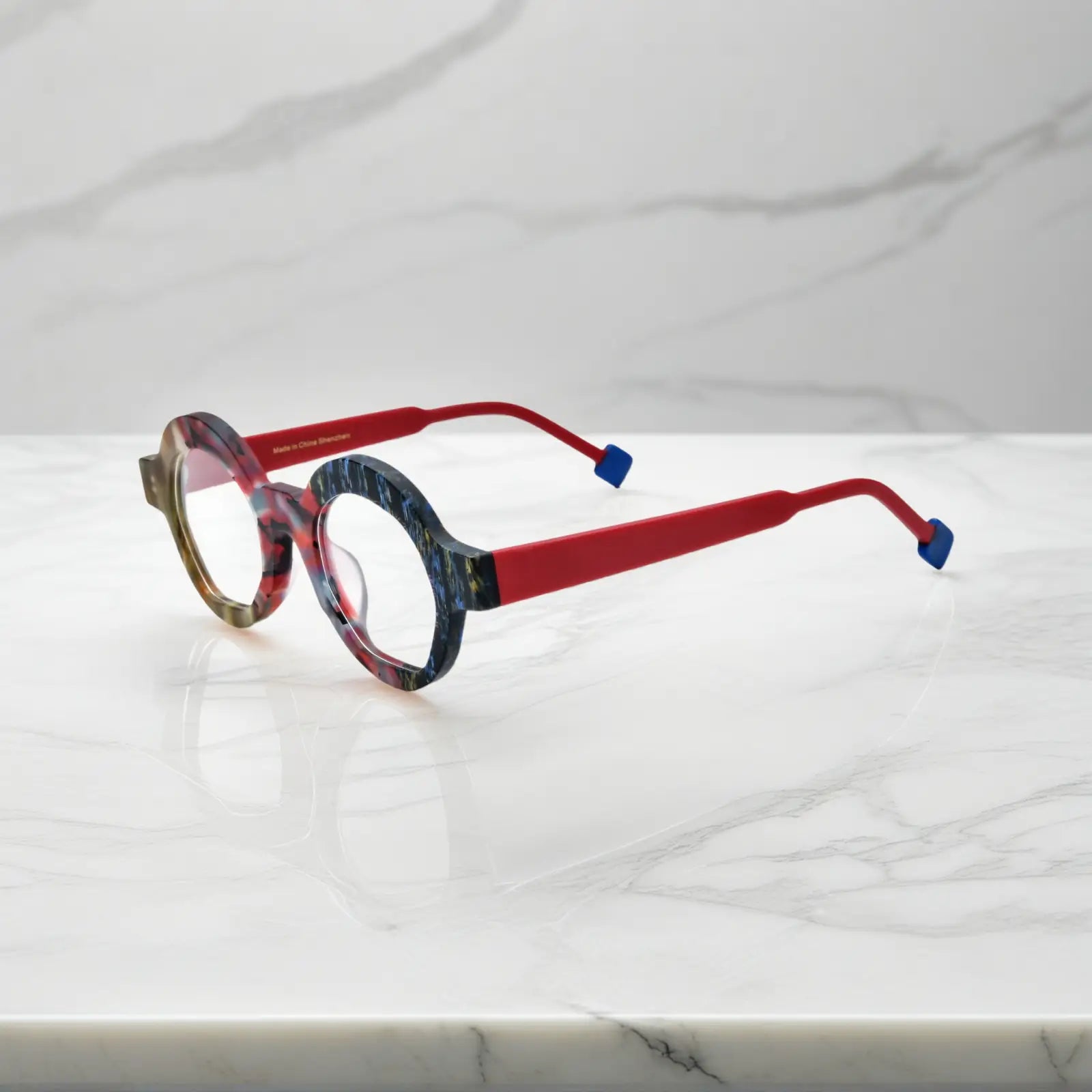 Side view of Crimson Nebula VL19355 frame showing deep red temples, angular polygon structure, and soft matte texture