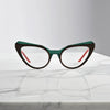 Front view of VoyueLens™ butterfly eyeglasses in Forest Marble color, featuring a sculpted matte acetate frame with earthy green swirls.