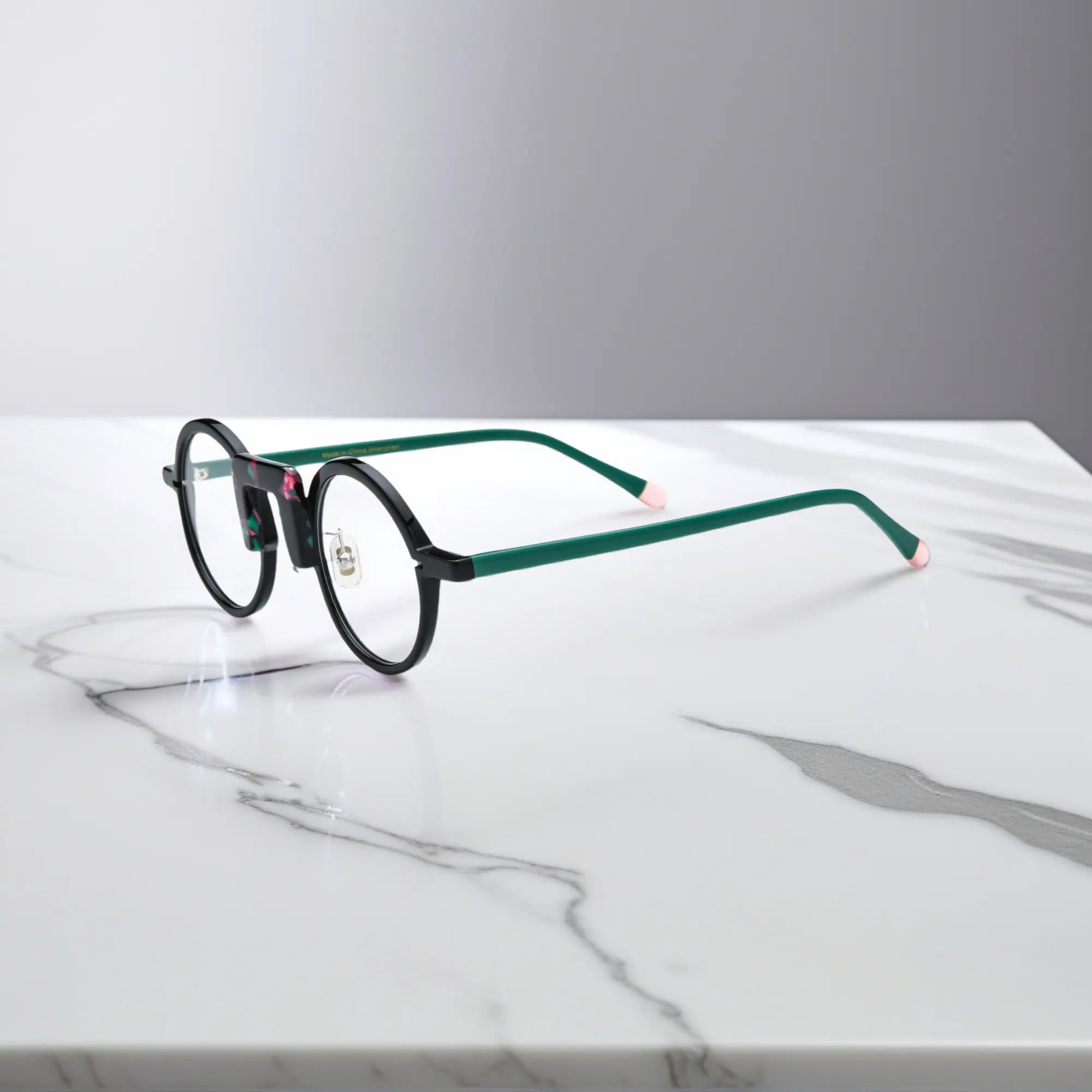 Side profile showing forest green and black blend frame