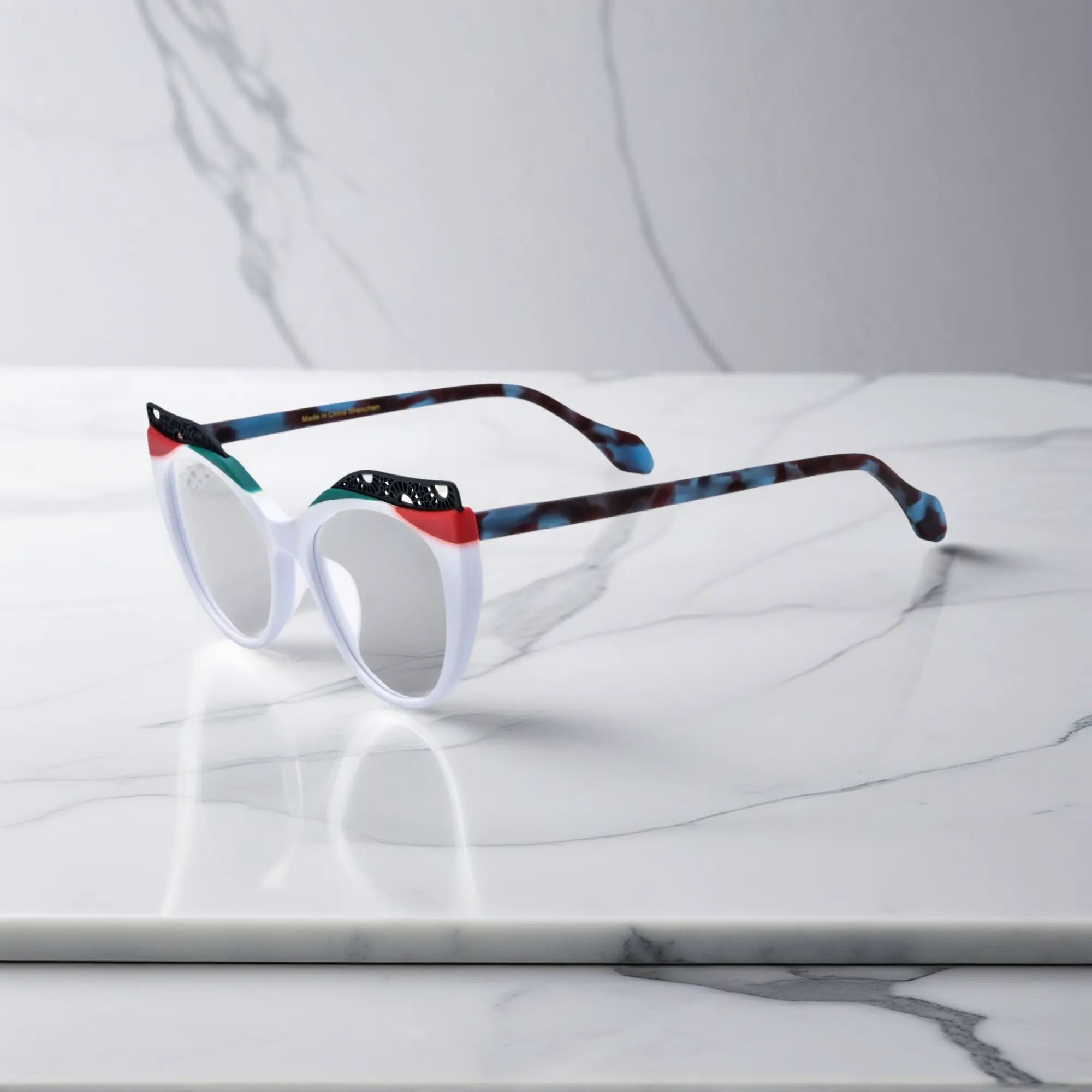 Side View of VoyueLens™ Ice Coral cat-eye eyeglasses with frosty white-to-coral fade and signature lace-pattern design.