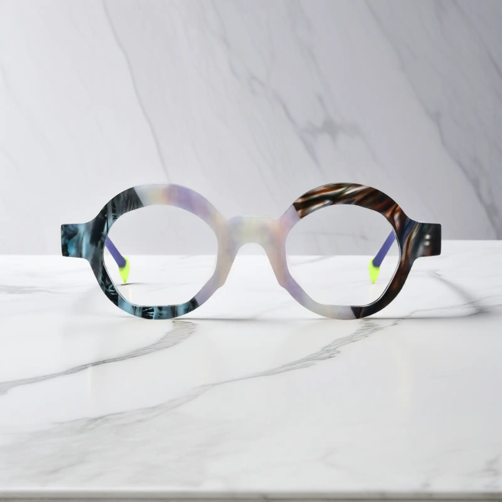 Front display of VoyueLens™ VL19355 Ice Marble polygon eyeglasses featuring a marbled matte finish and frosty purple temple arms