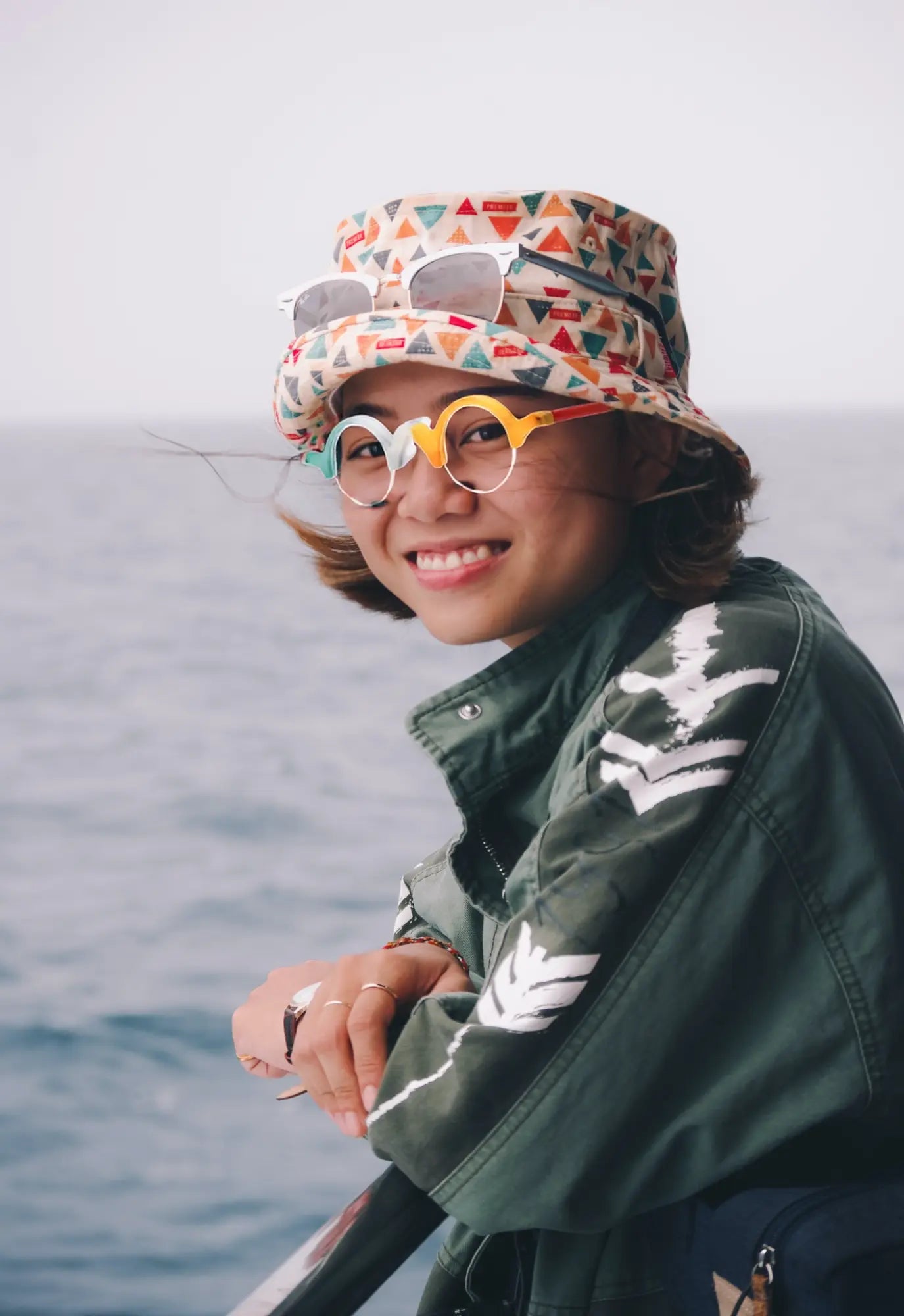 Outdoor model wearing VoyueLens™ Ivory-Orange semi-rimless browline eyeglasses, demonstrating stylish matte frame fit.