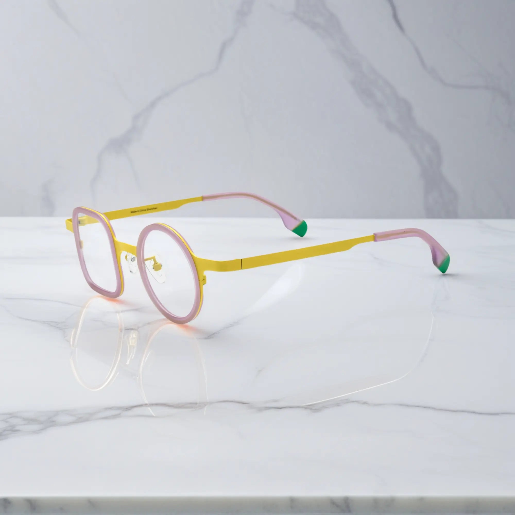 Side angle of Lemon Pink variant showing titanium temples and soft matte finish.