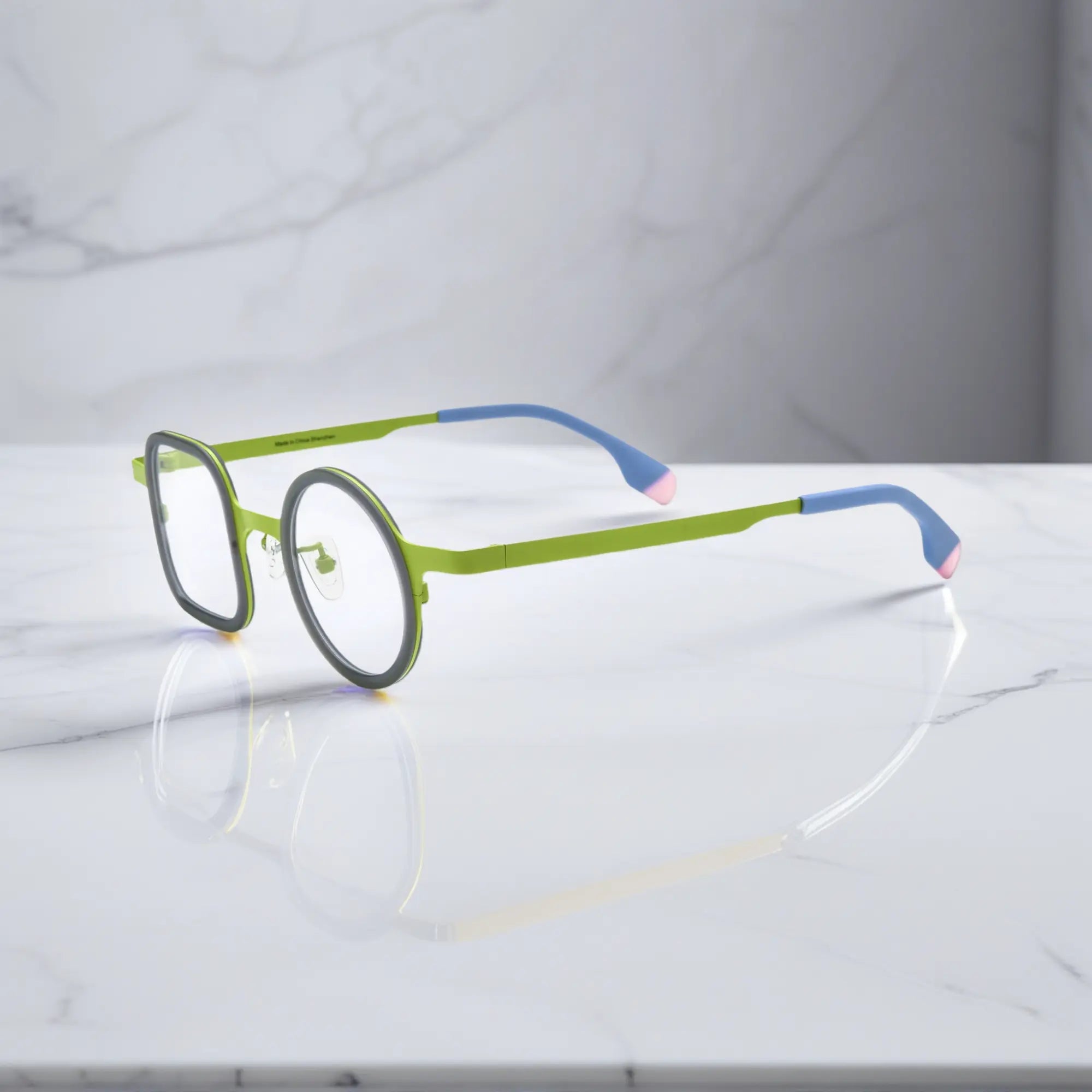 Side view displaying green-accented temples with gradient tip finish.