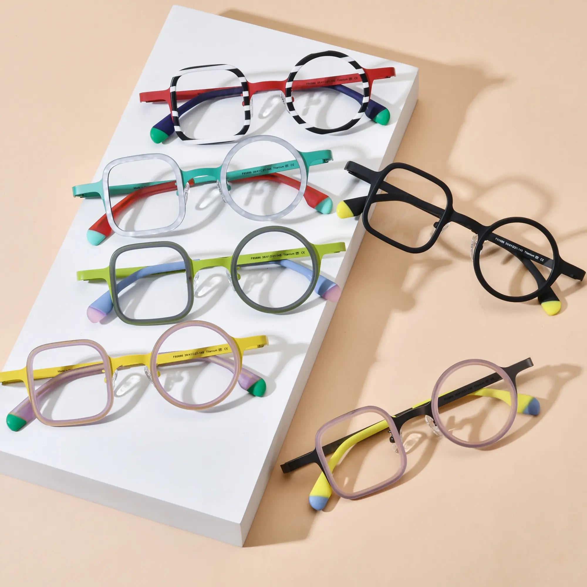 Group photo of VoyueLens™ VL185886 eyeglasses in all six color variants. Top-down angled layout showing asymmetric acetate-titanium frames with colorful temple tips. Perfect for artistic, lightweight prescription eyewear lovers.