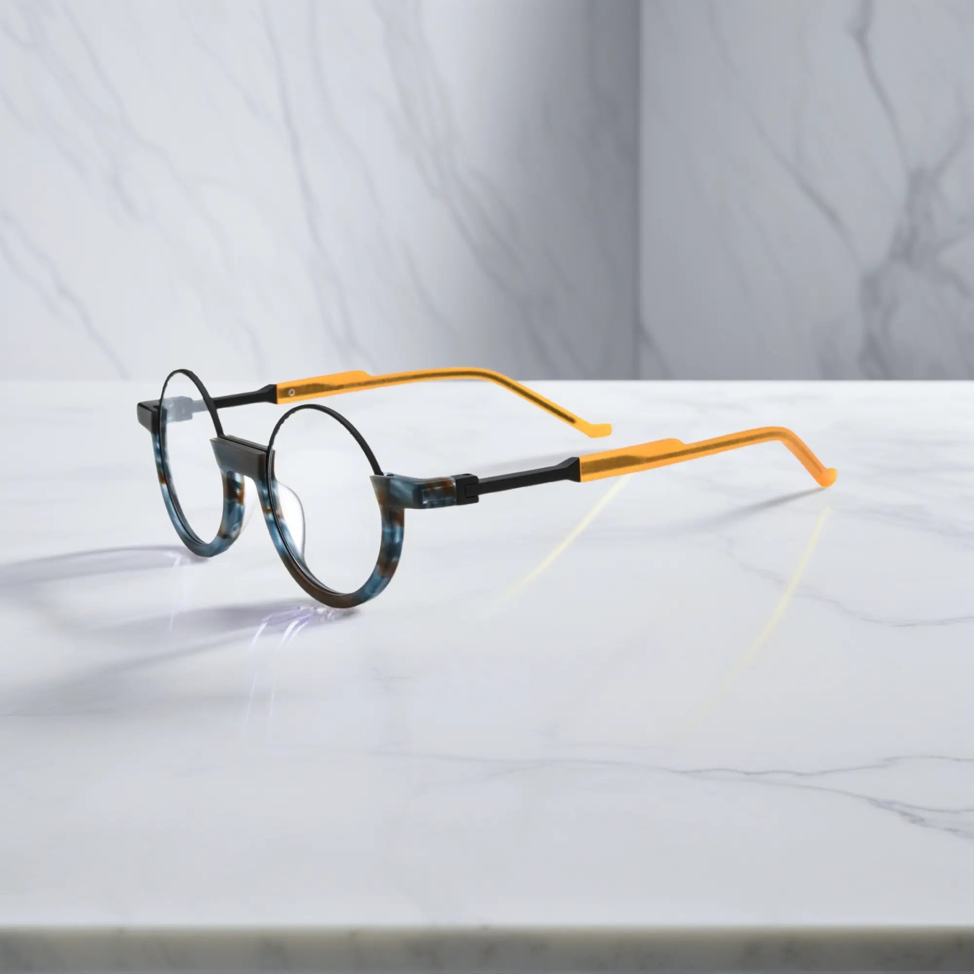 Side profile showcasing marine green tortoiseshell arms with classic round frame aesthetics.