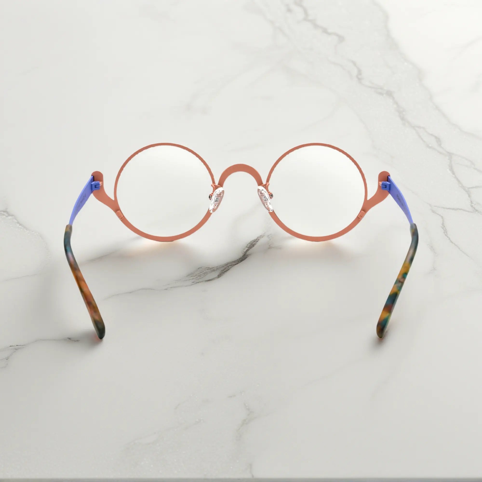 Back view of Pastel Forest VoyueLens™ titanium round glasses with curved temple arms