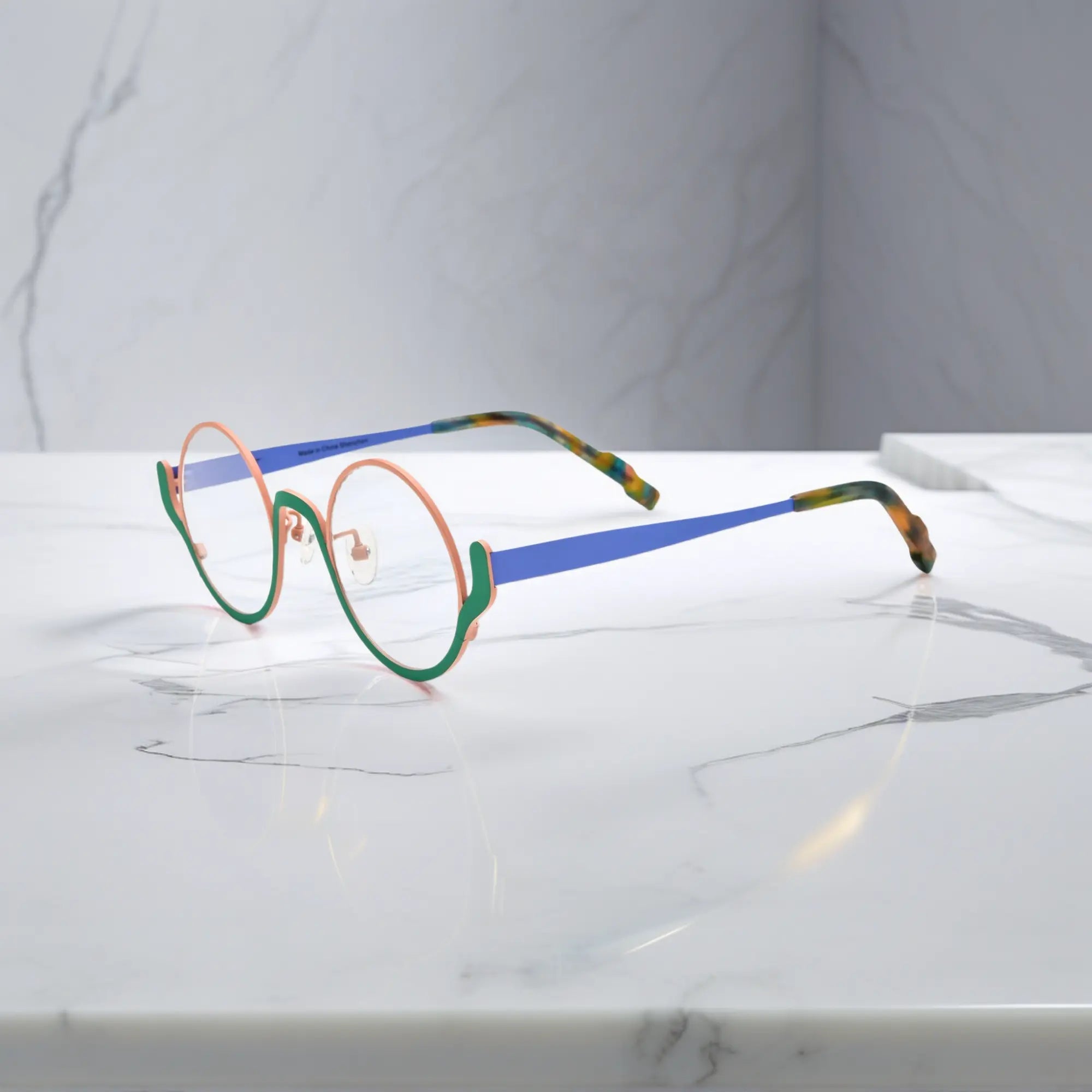 Side view showing blue titanium temple and tortoiseshell tips – Pastel Forest variant