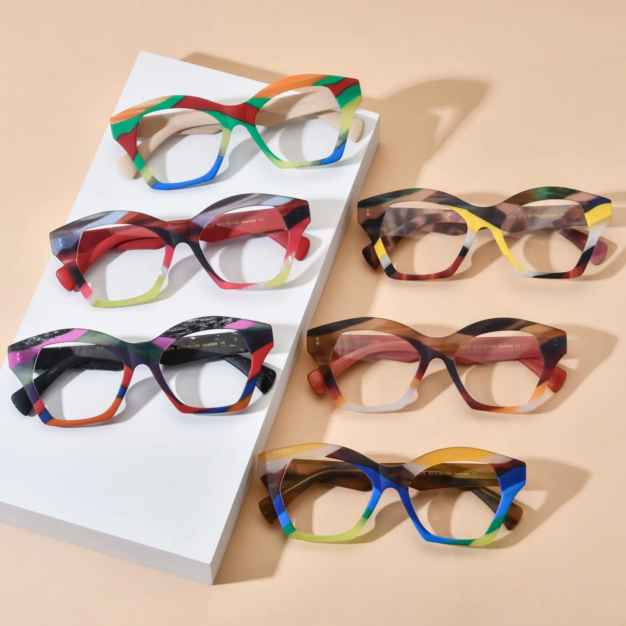 Top-down view of all six VoyueLens™ Rainbow Chic Eyeglasses variants, showcasing the colorful butterfly frames in Rainbow Cream, Rainbow Flame, Rainbow Noir, Aurora Mosaic, Crimson Storm, and Ocean Carnival, arranged aesthetically for a vibrant and stylish product overview.