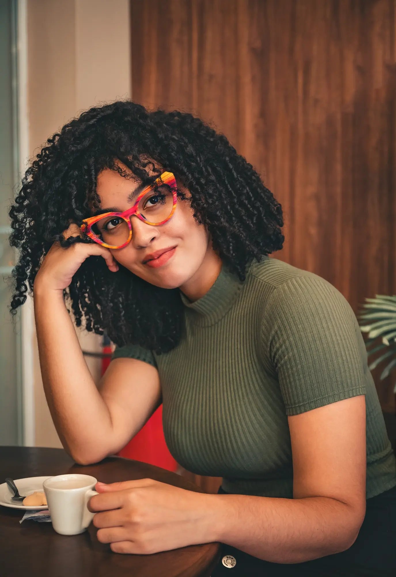Model in urban setting wearing VoyueLens™ Rainbow Stripe butterfly eyeglasses – a vibrant statement accessory.