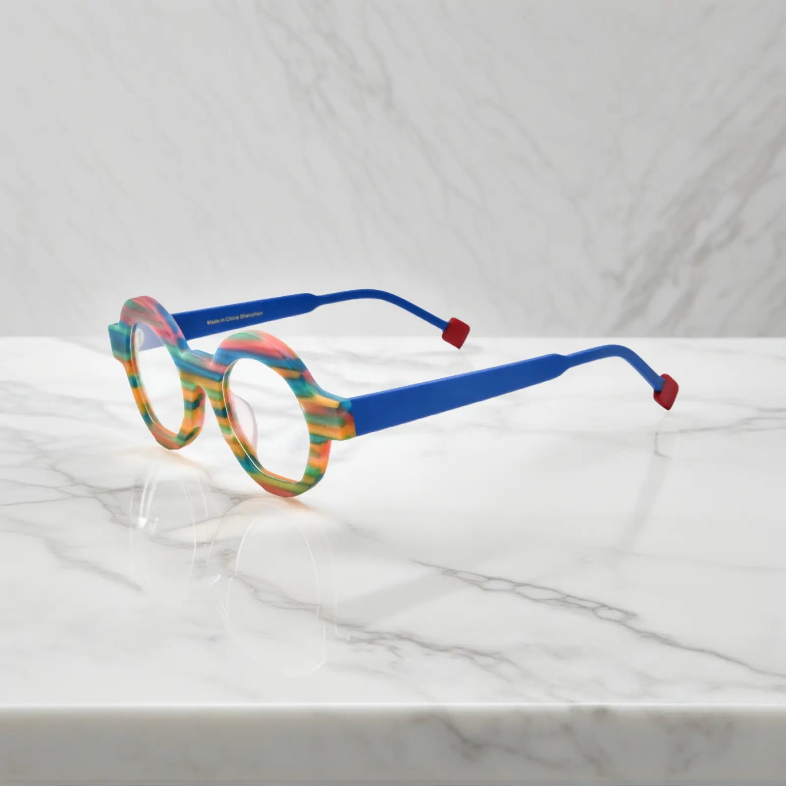 Side view of Rainbow Stripe VoyueLens™ VL19355 glasses showing multi-color matte acetate temples and geometric polygon silhouette