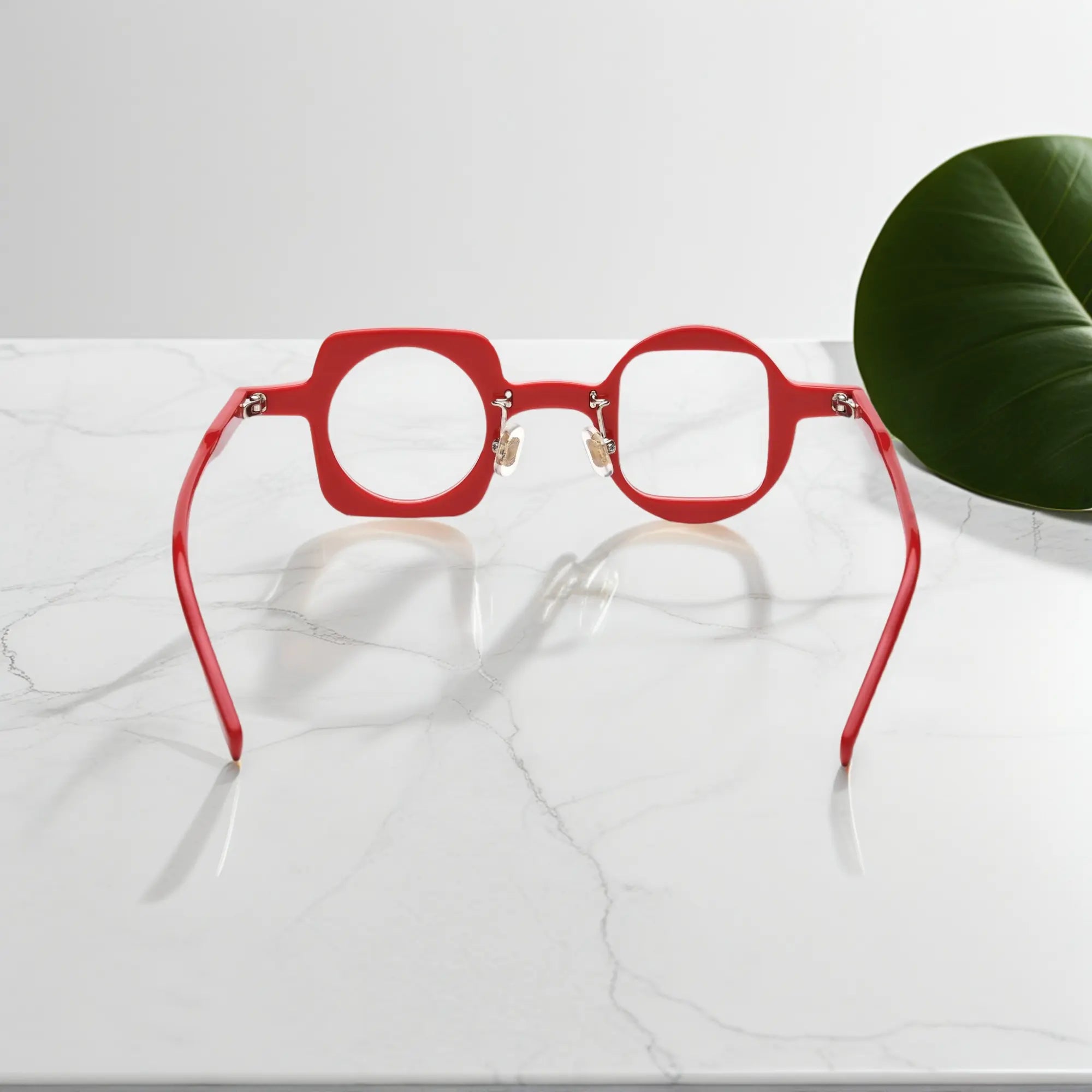 Back view showcasing VoyueLens red asymmetrical glasses with silicone nose pads and premium acetate construction.