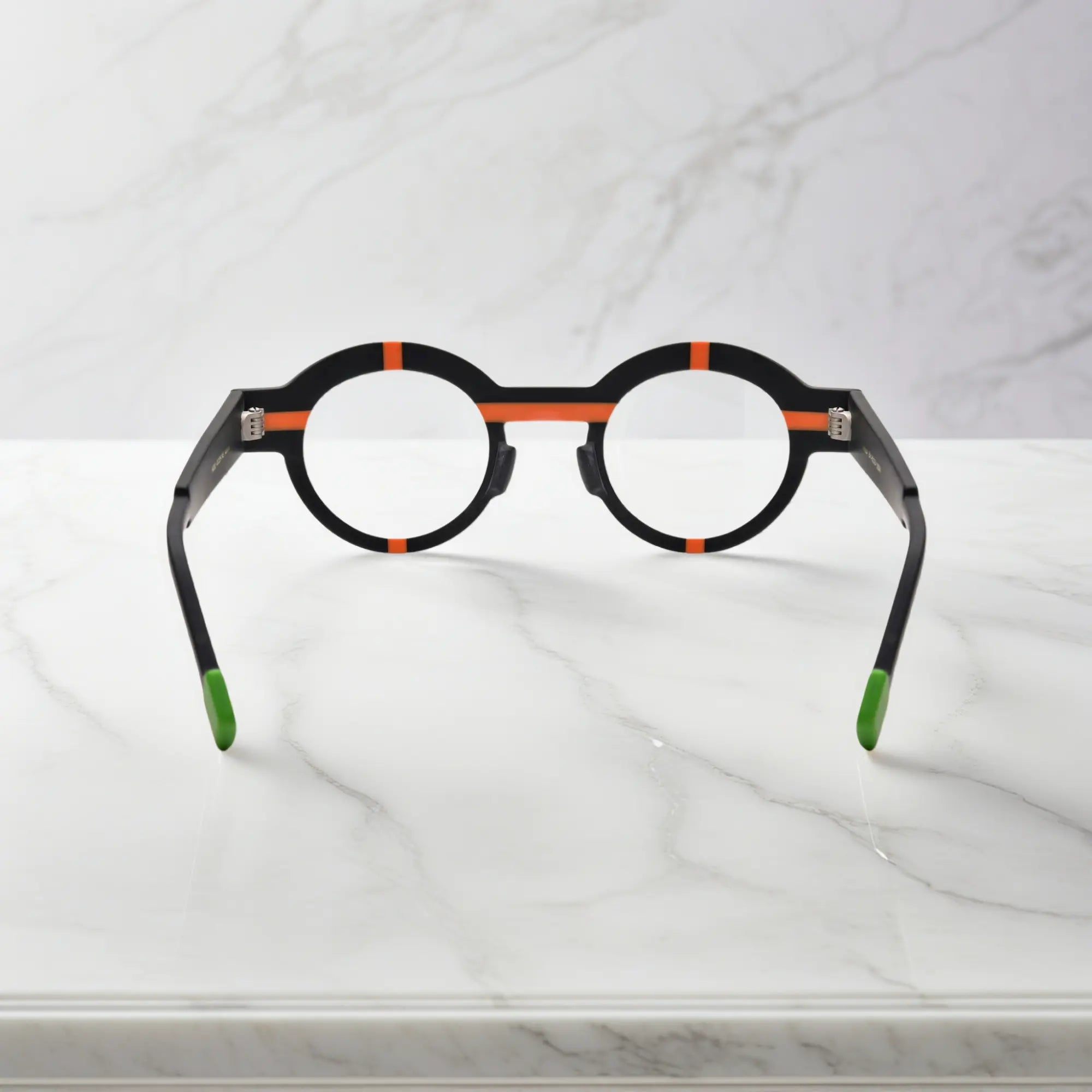 Angled perspective highlighting the structured matte acetate frame in charcoal black.