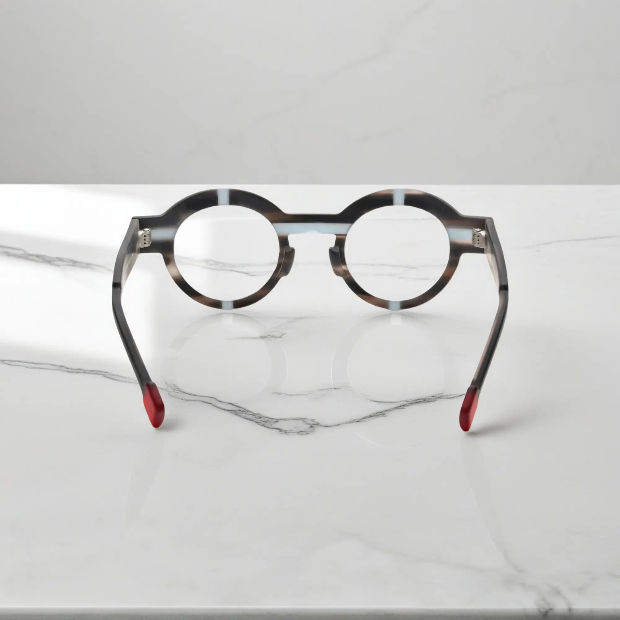 Angled view of slate gray VoyueLens™ glasses showing the round shape and muted matte surface.