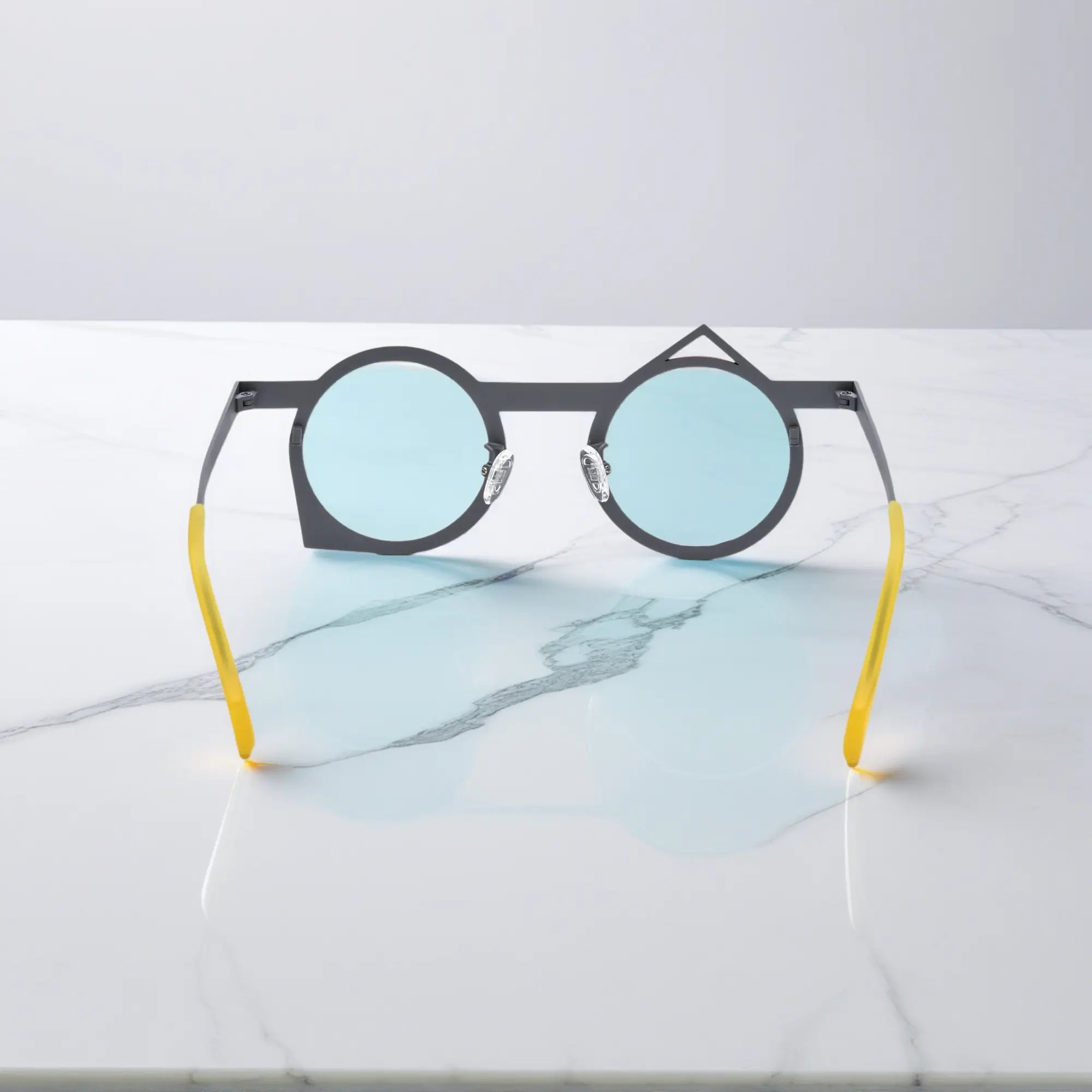 Rear perspective of VoyueLens™ VL185801 red-grey polygonal glasses made of corrosion-resistant, lightweight titanium.