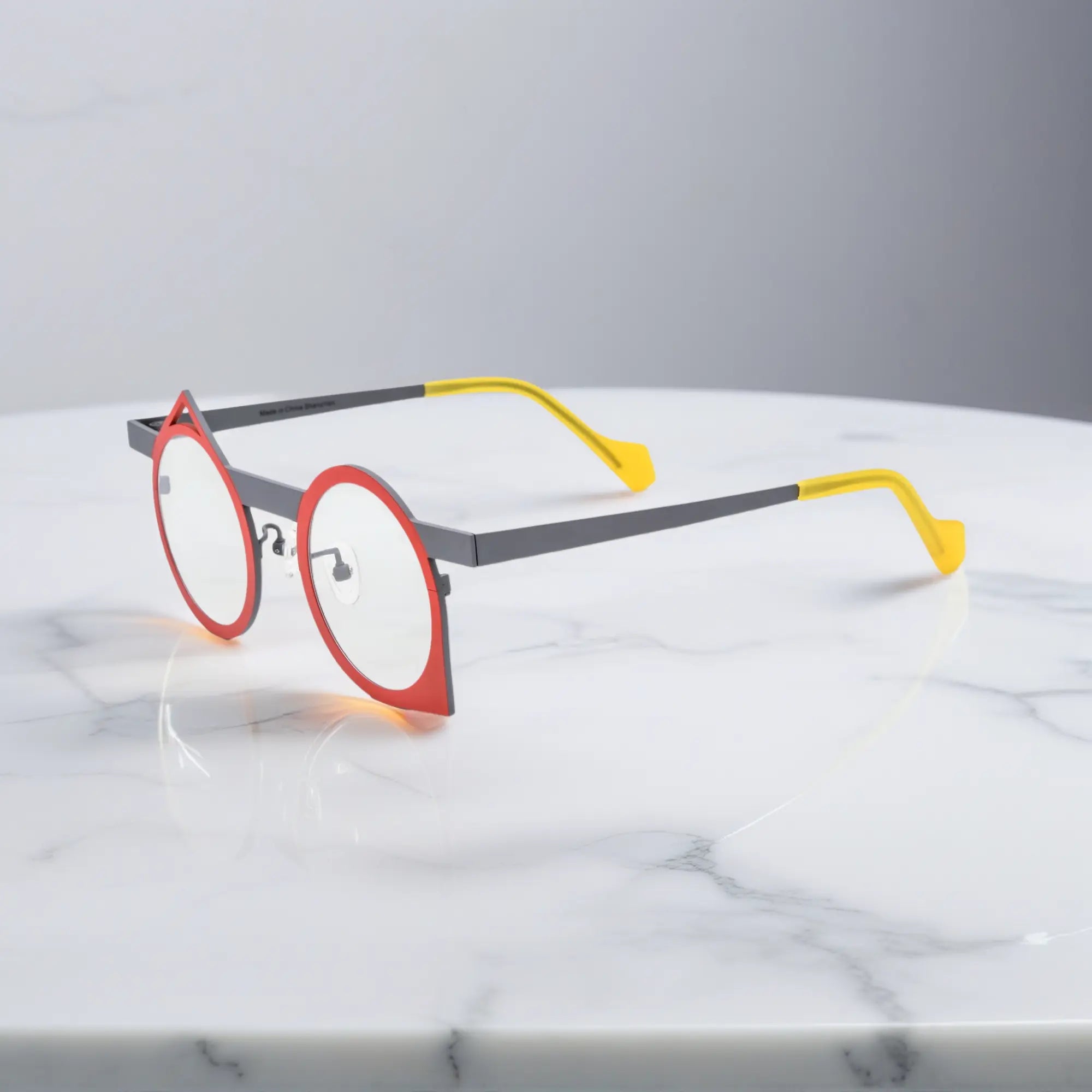 Profile view of VoyueLens™ Scarlet Slate titanium eyeglasses showing retro polygonal shape and minimalist finish.