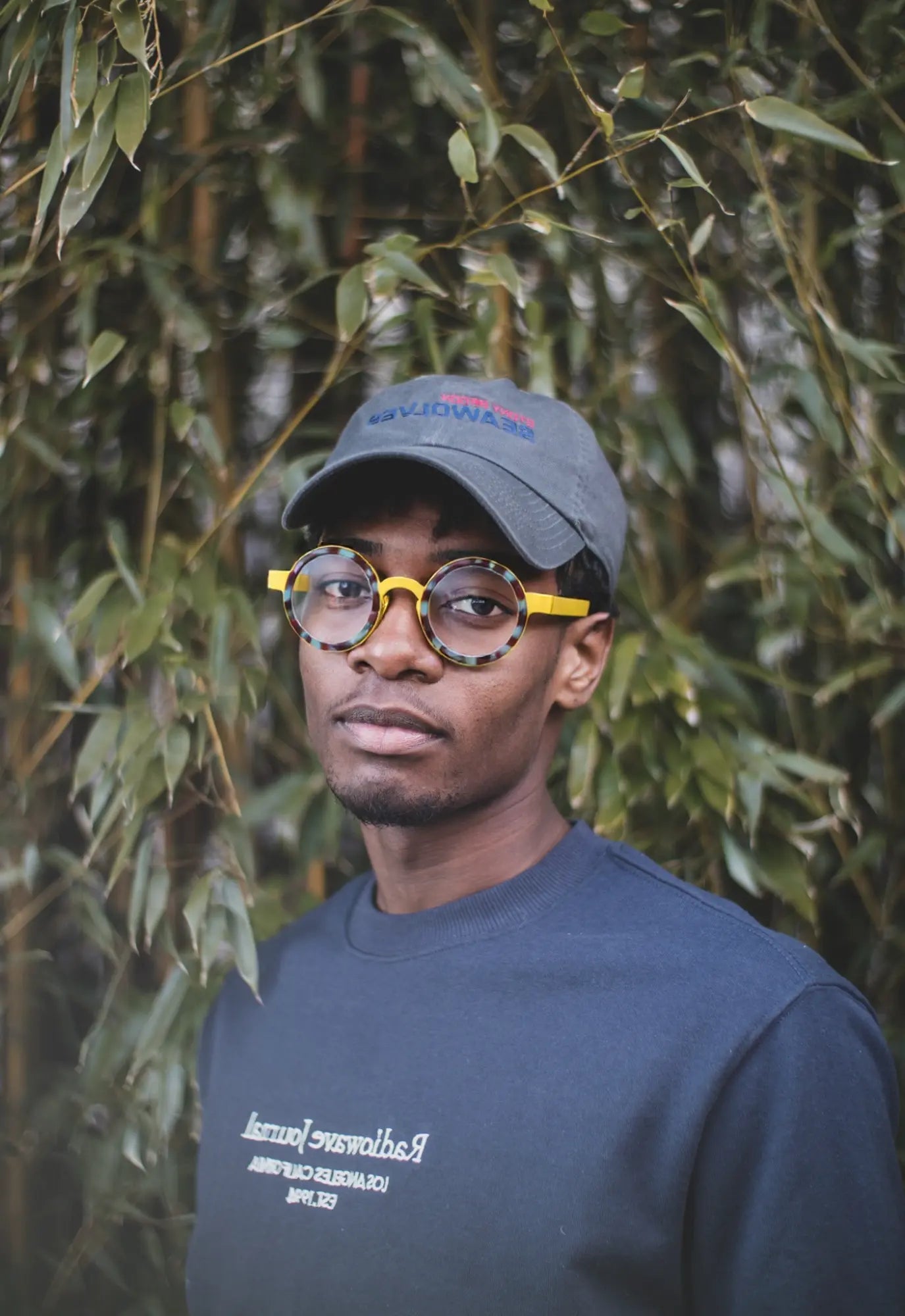 Model showcasing Sunshine Mirage titanium round eyeglasses