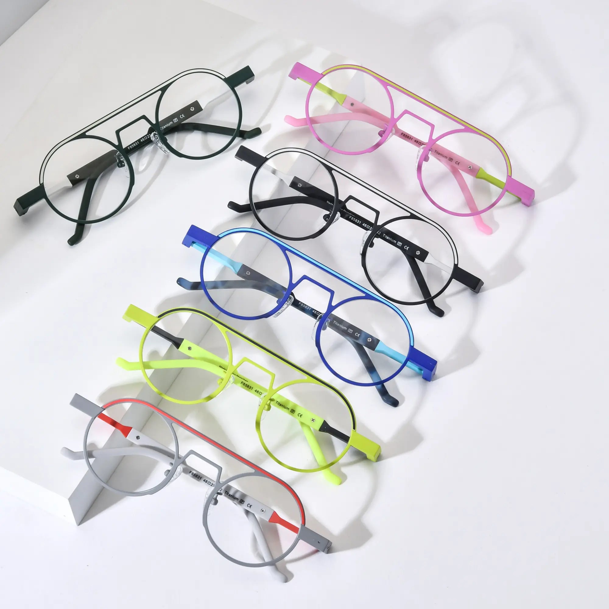 Top-down view of VoyueLens™ NeoPilot titanium aviator glasses in six vibrant color-block variants including Candy Lime, Graphite Black, Glacier Blue, Neon Moss, Urban Ink, and Chrome Ember – lightweight and prescription-ready eyewear.