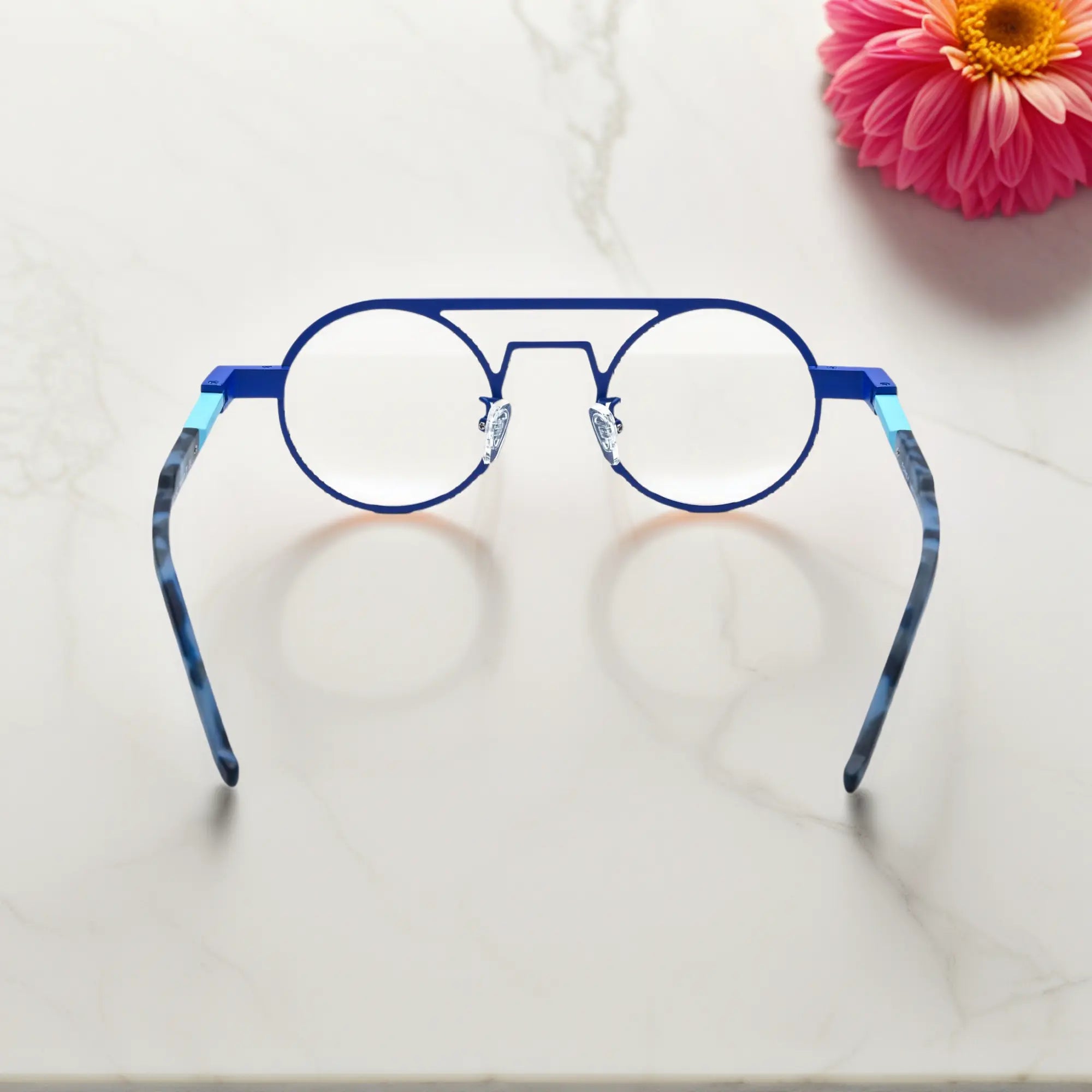 Rear angle displaying the ergonomic nose pads and lightweight design in Glacier Blue icy titanium aviator frame with a cool, futuristic tone