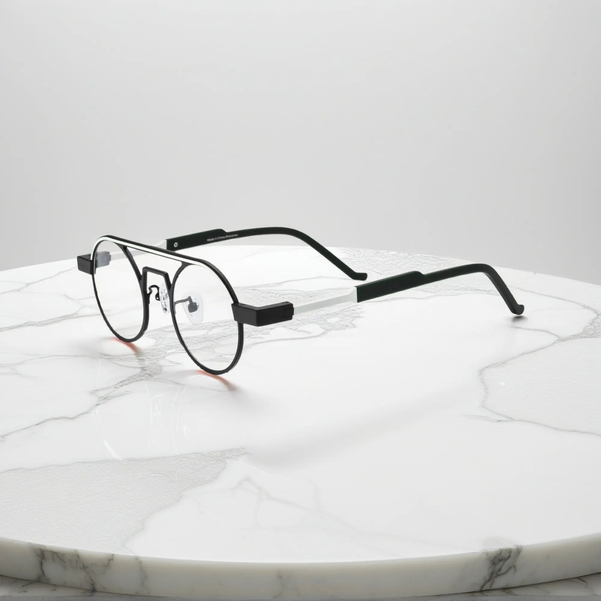 Side profile showing the slim titanium arms and hinge structure in Graphite Black matte titanium frame for a modern minimalistic look