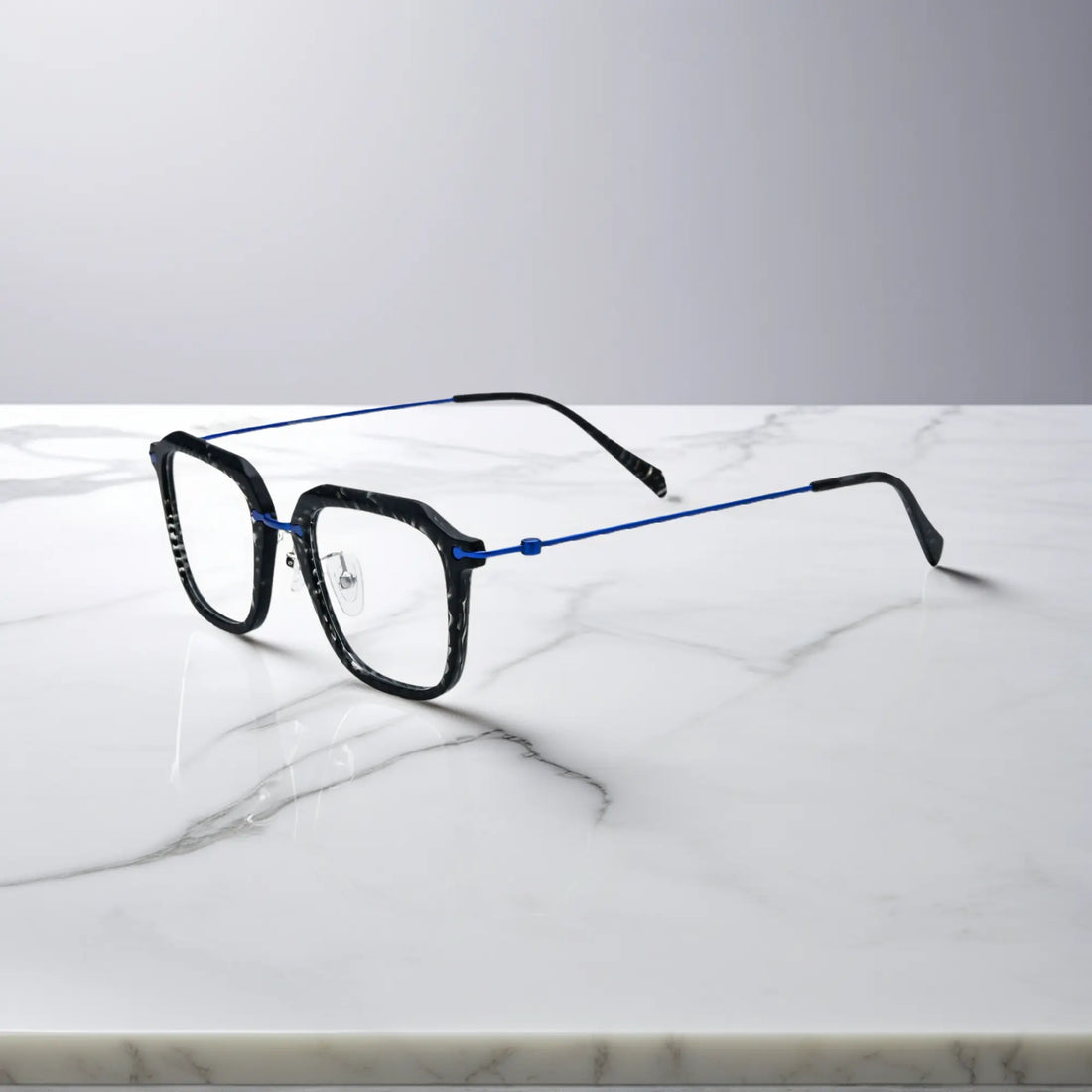 Sleek side view of the black frame with cool-toned titanium temple detailing.