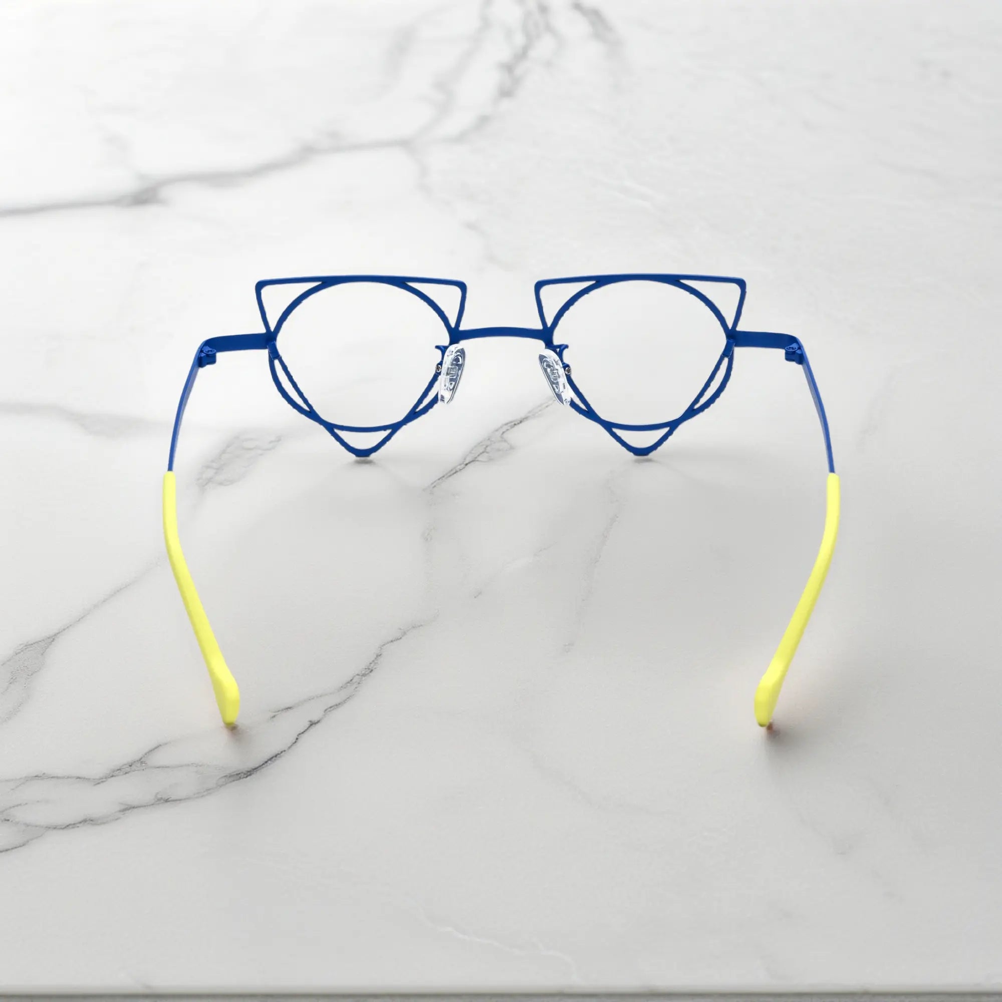 Back angle revealing artistic frame curves of VoyueLens™ Cobalt Chartreuse geometric glasses, crafted from lightweight titanium