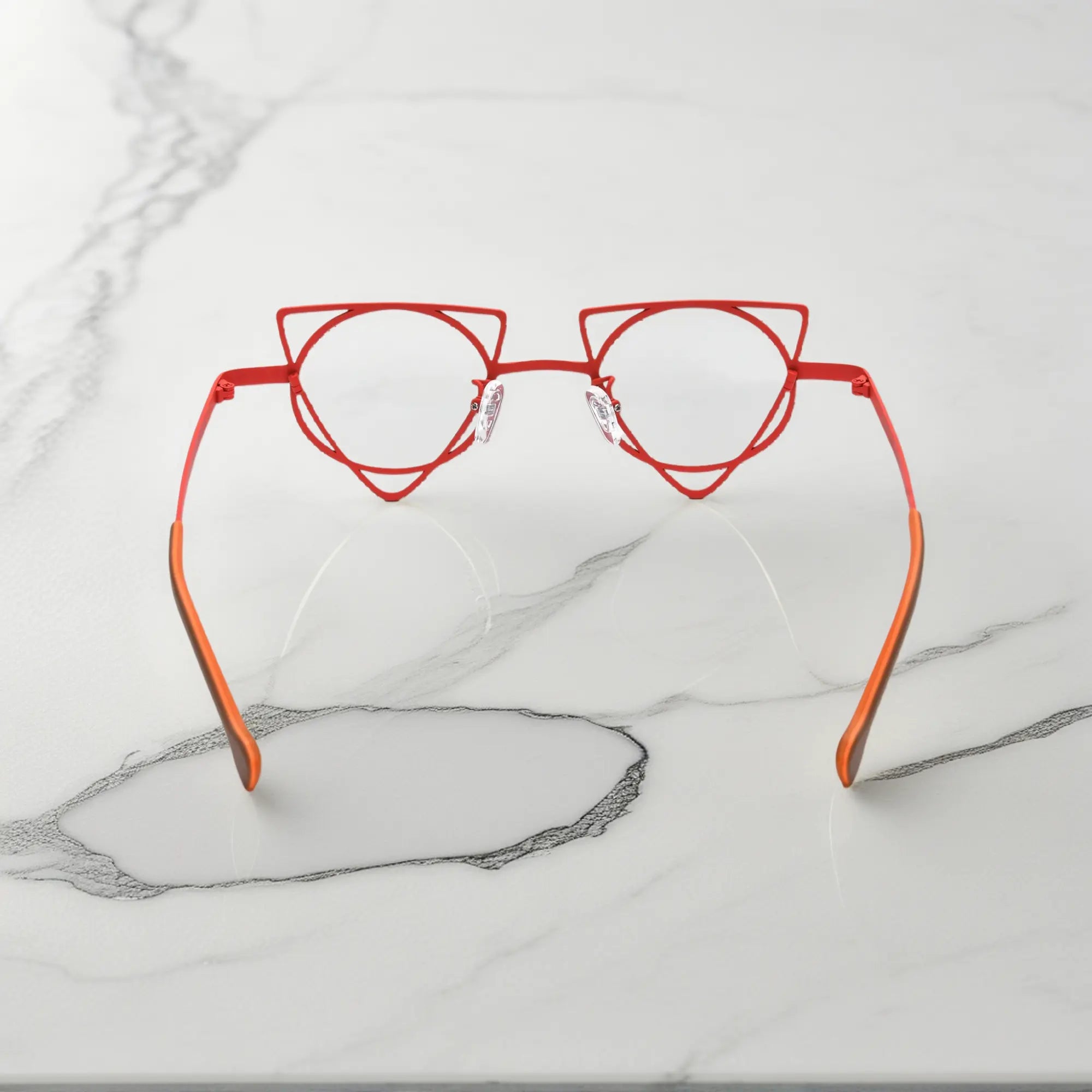 Back angle revealing artistic frame curves of VoyueLens™ Skyfire Red geometric glasses, crafted from lightweight titanium