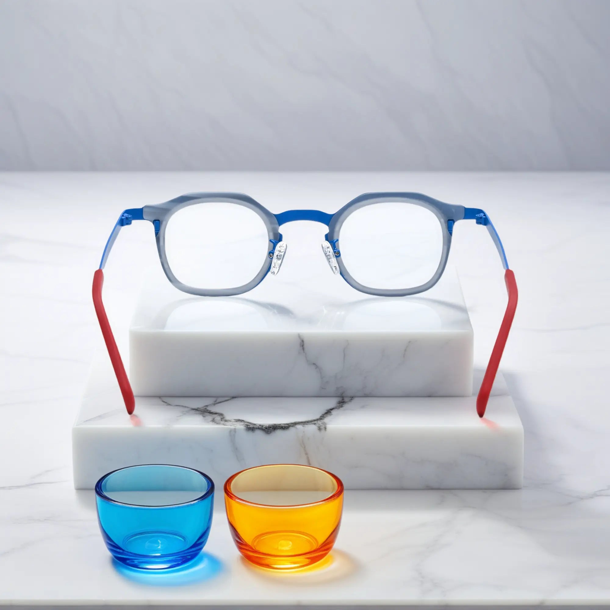 Rear view of VoyueLens™ Ocean Signal eyeglasses showing a deep blue acetate front and vibrant red titanium temples.