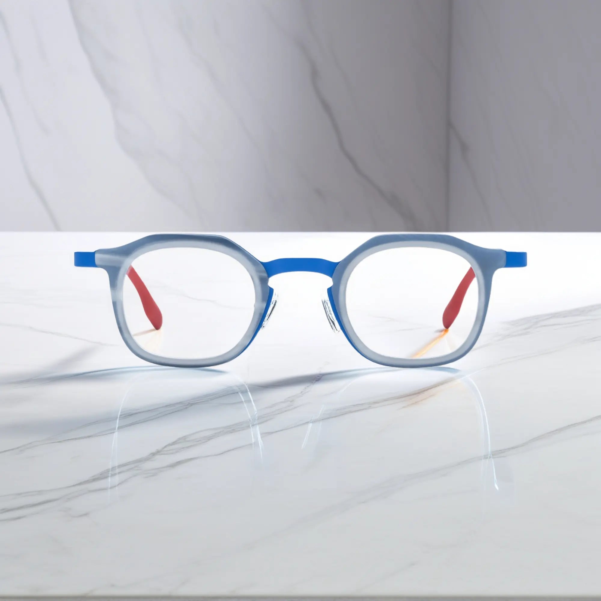 Front view of VoyueLens™ Ocean Signal square eyeglasses with a deep blue acetate front and vibrant red titanium temples.
