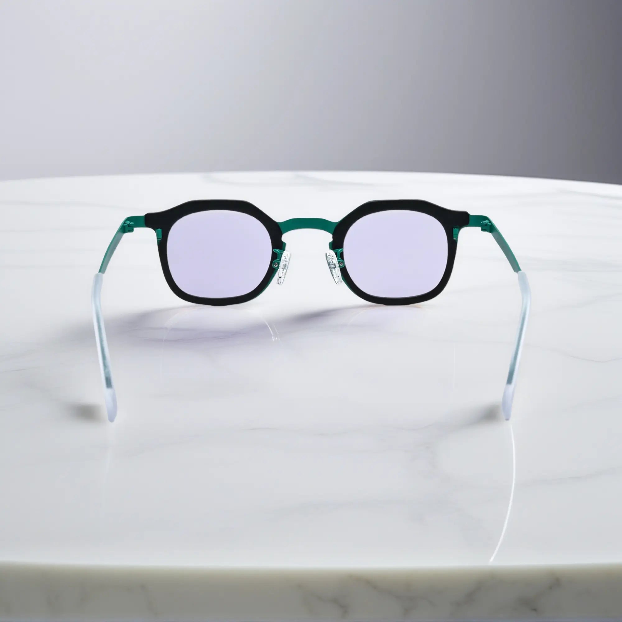 Rear view of VoyueLens™ Forest Frost eyeglasses showing a forest green acetate frame with frosted silver titanium temples.