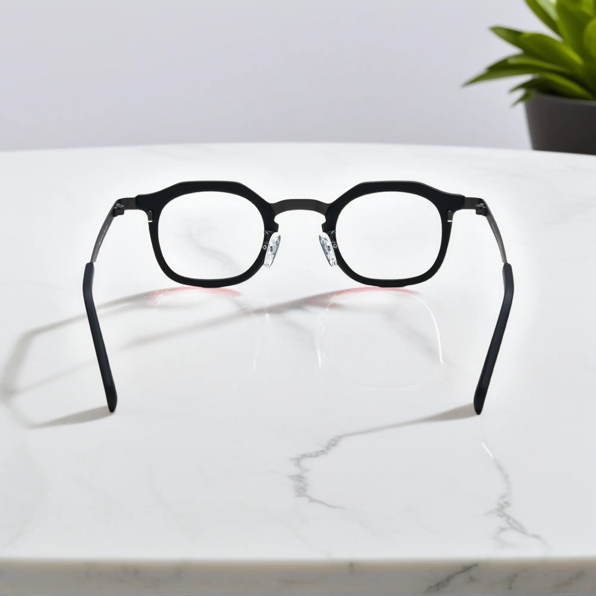 Rear view of VoyueLens™ Graphite Mist eyeglasses showing a matte grey acetate front and black titanium temples.