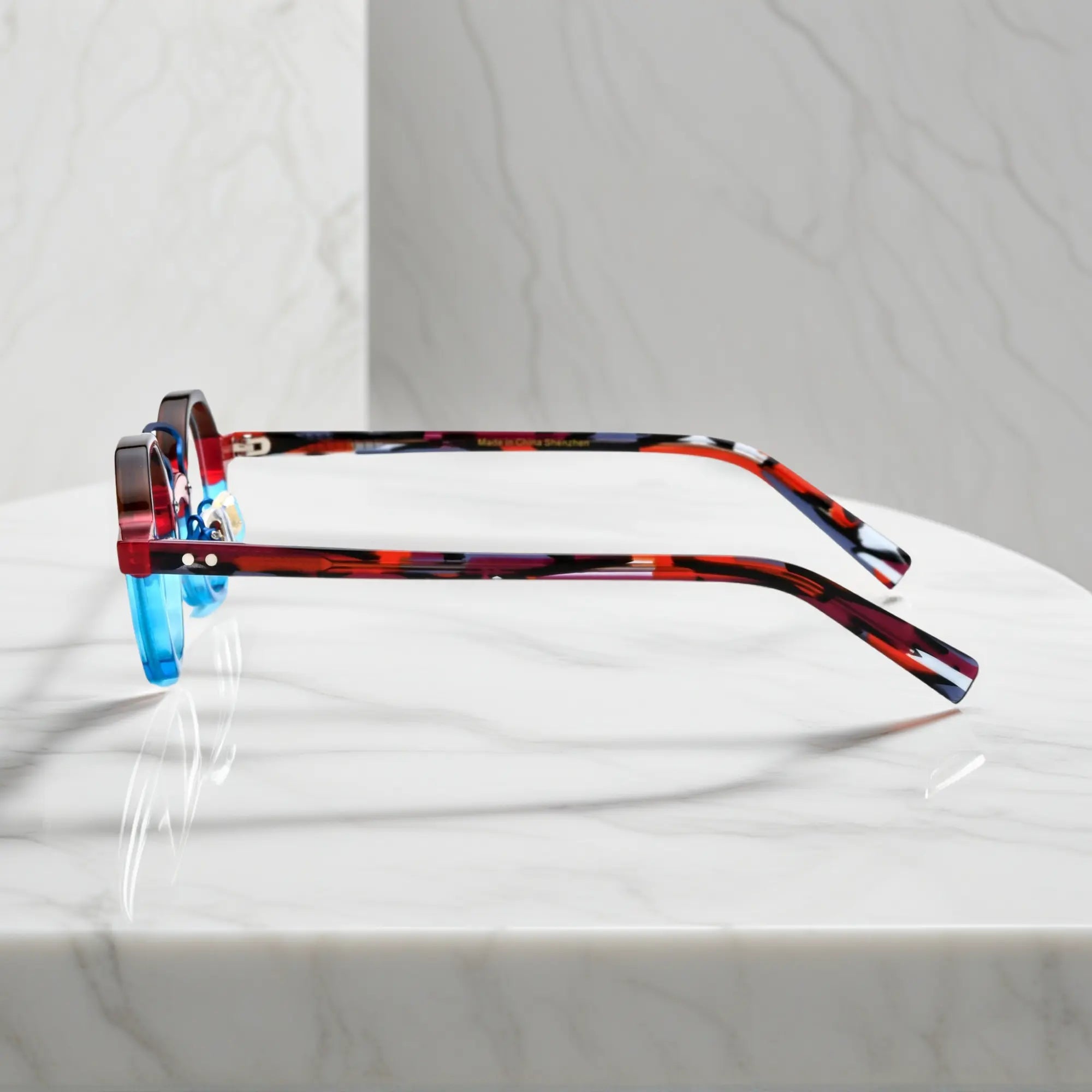 Side profile of VoyueLens™ VL19244 unisex acetate eyeglasses in bold Crimson Blue Fusion for petite faces.Red tortoise shell temples