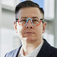 Man wearing VoyueLens™ VL19352 square eyeglasses in Aurora Fade color, professional portrait in natural indoor lighting.