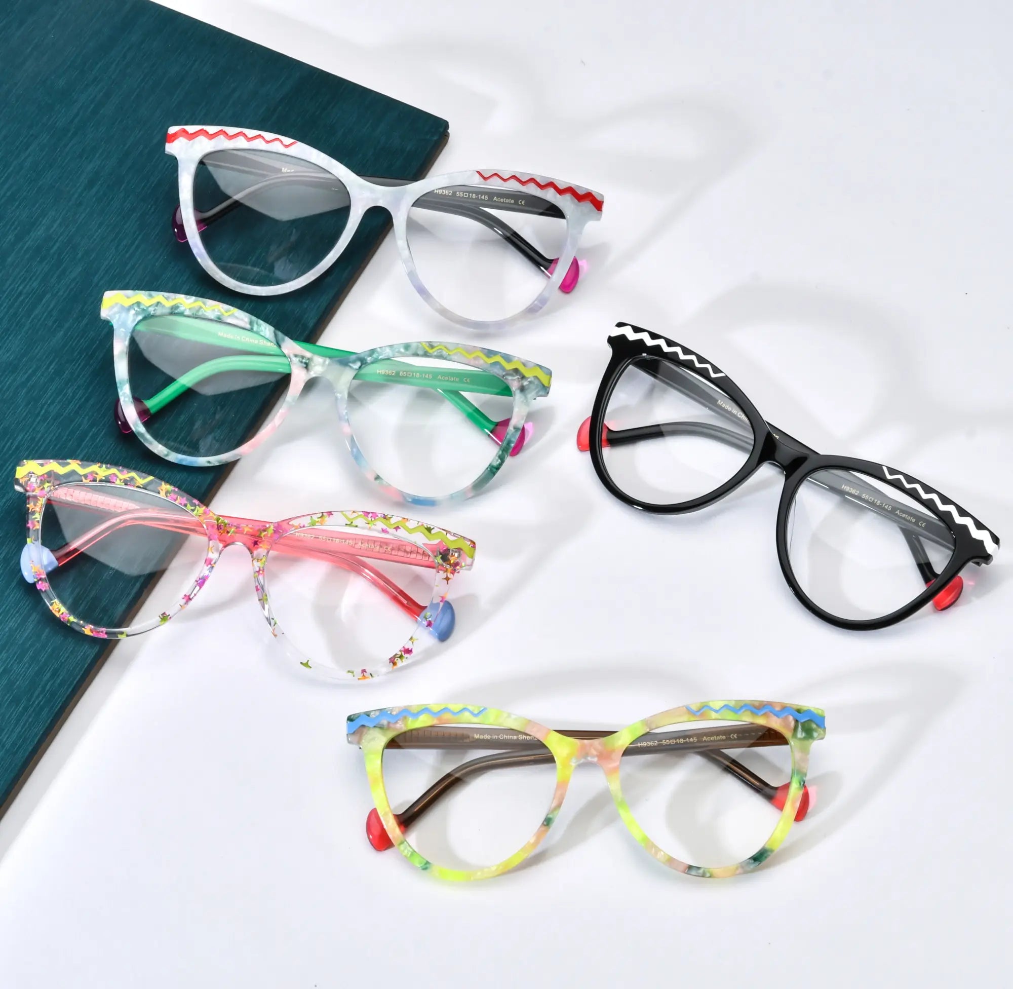 Overview of VoyueLens VL19362 butterfly eyeglasses in five vibrant colors including pearl white, floral green, amber fade, classic black, and blossom pink, laid out on a white background