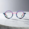 Front view of VoyueLens™ Chromatic Orbit Eyeglasses in Blue Coral showcasing its bold round silhouette and vibrant color scheme.