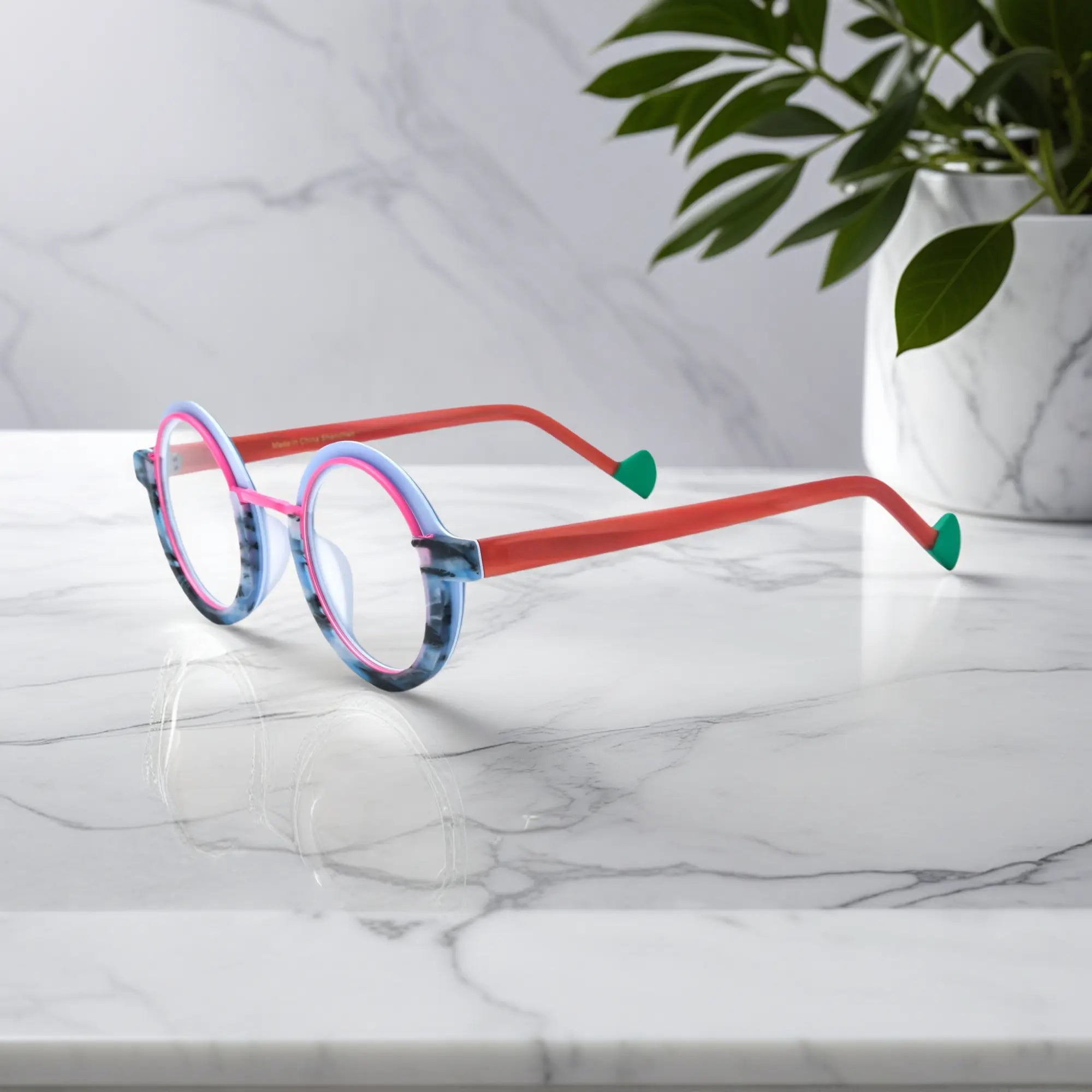 Side angle of VoyueLens™ eyeglass frames in Blue Coral highlighting temple structure and artistic design.