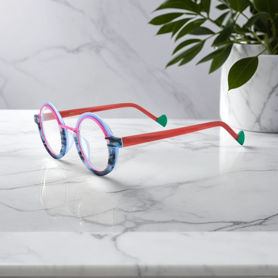 Side angle of VoyueLens™ eyeglass frames in Blue Coral highlighting temple structure and artistic design.