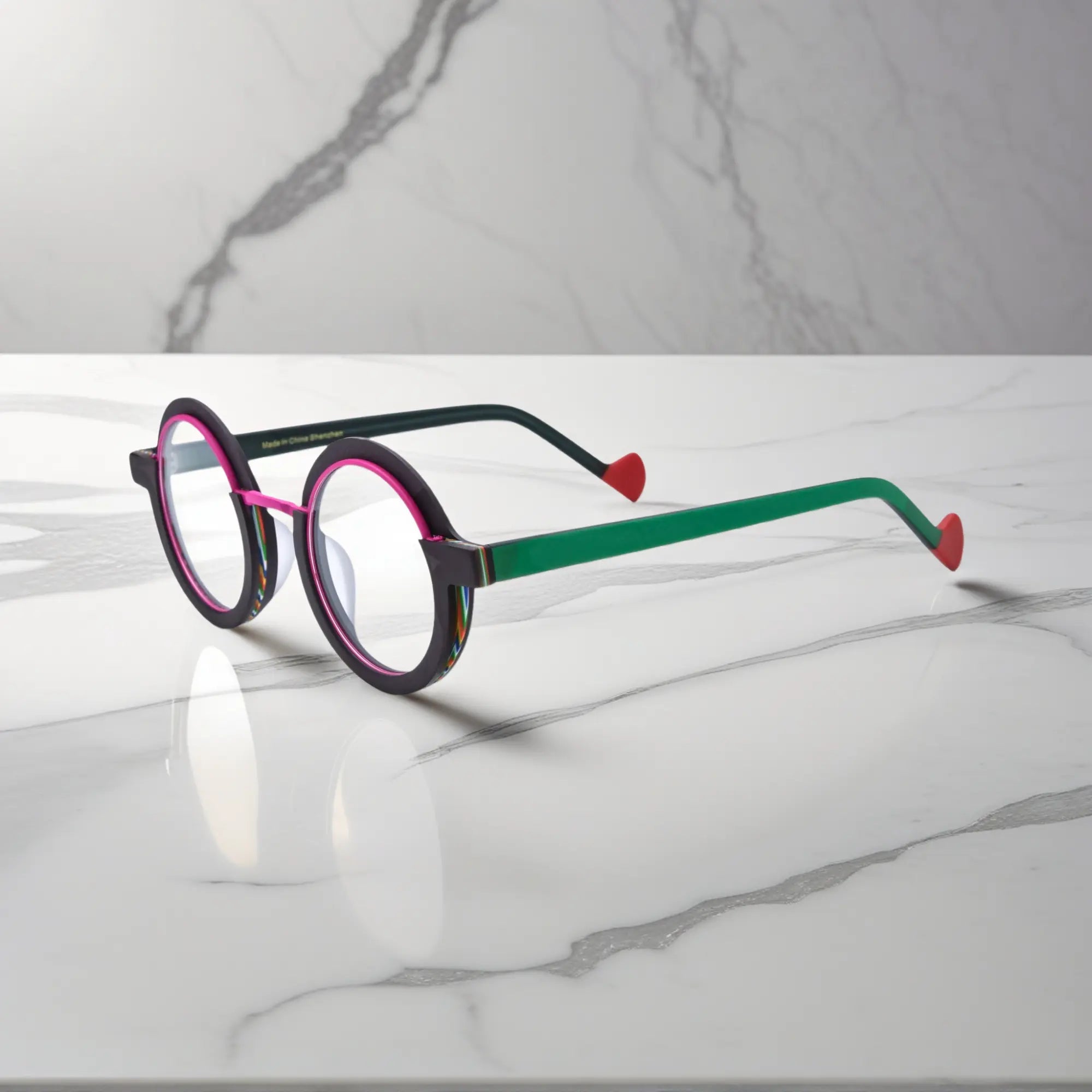 Side angle of VoyueLens™ eyeglass frames in Crimson Edge highlighting temple structure and artistic design.