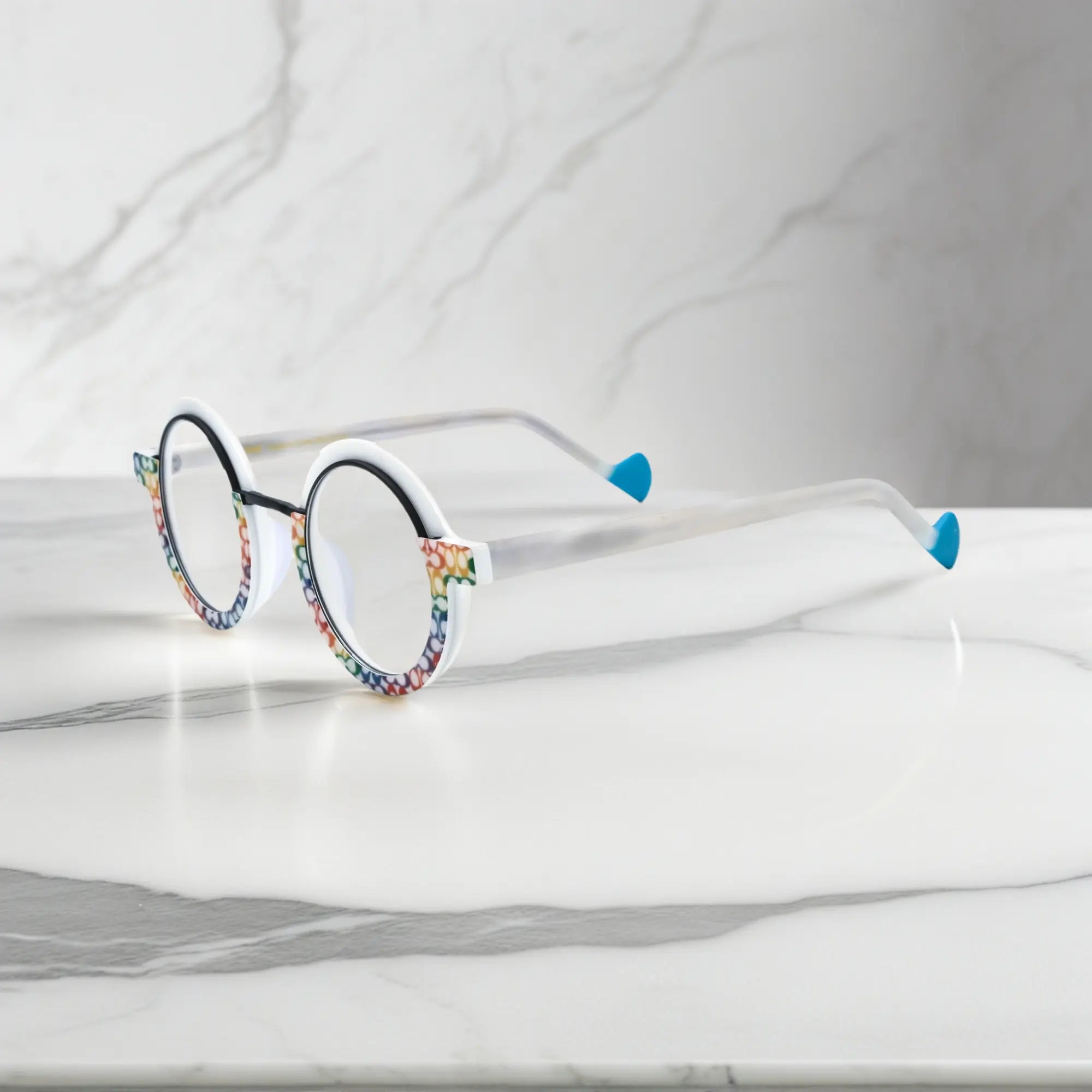 Side angle of VoyueLens™ eyeglass frames in Mosaic Frost highlighting temple structure and artistic design.