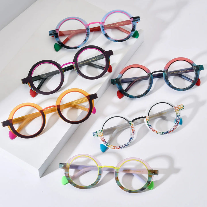 Full collection display of VoyueLens™ Chromatic Orbit Eyeglasses featuring all six color variants – Blue Coral, Ocean Blaze, Crimson Edge, Mosaic Frost, Citrus Orbit, and Lilac Bloom – arranged in a modern, minimalist flat lay presentation with vibrant round frames.