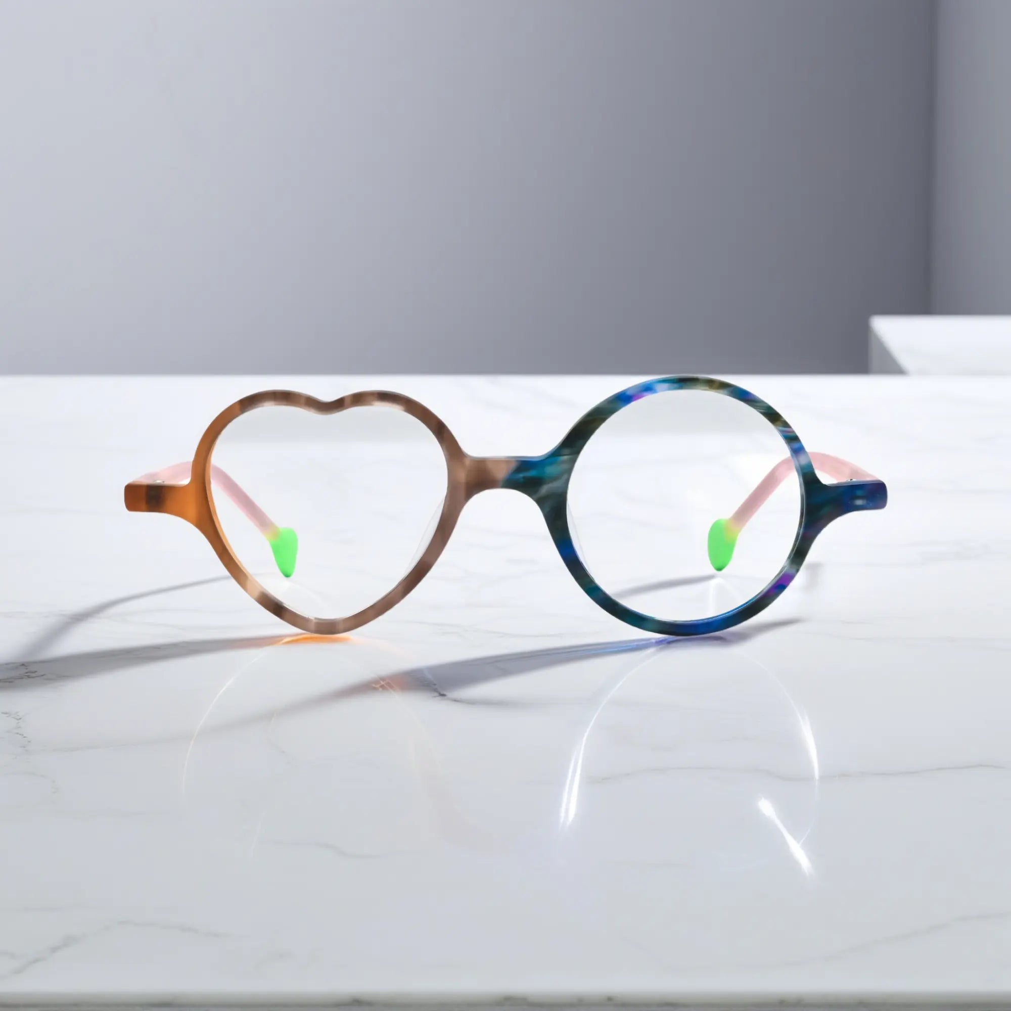 Front view of VoyueLens™ VL19377 in Cocoa Marble, highlighting heart and round lens design. Chocolate brown marble pattern with light blue contrast, earthy yet fun.