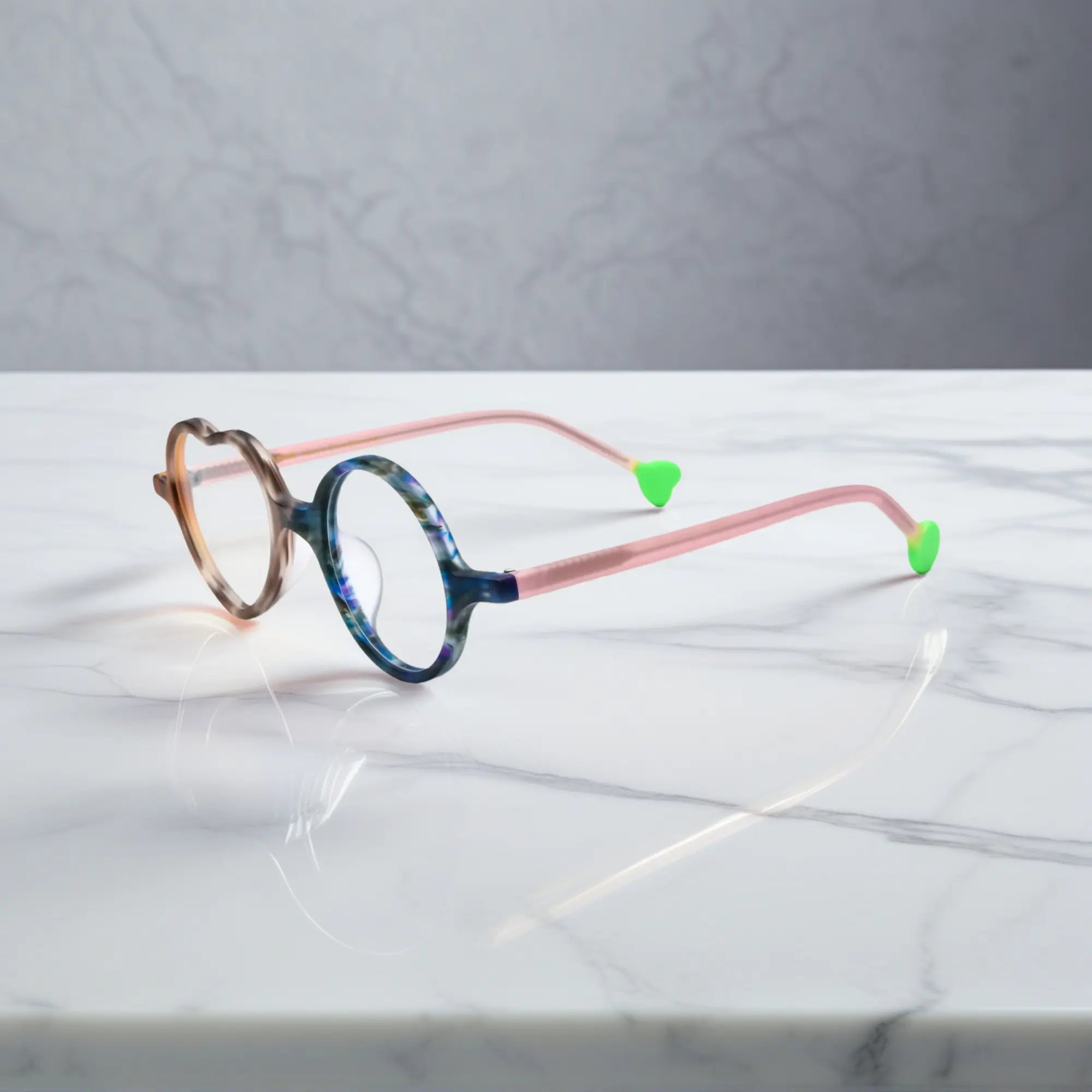 Side view of Cocoa Marble variant, showcasing frame thickness and temple arm structure. Chocolate brown marble pattern with light blue contrast, earthy yet fun.